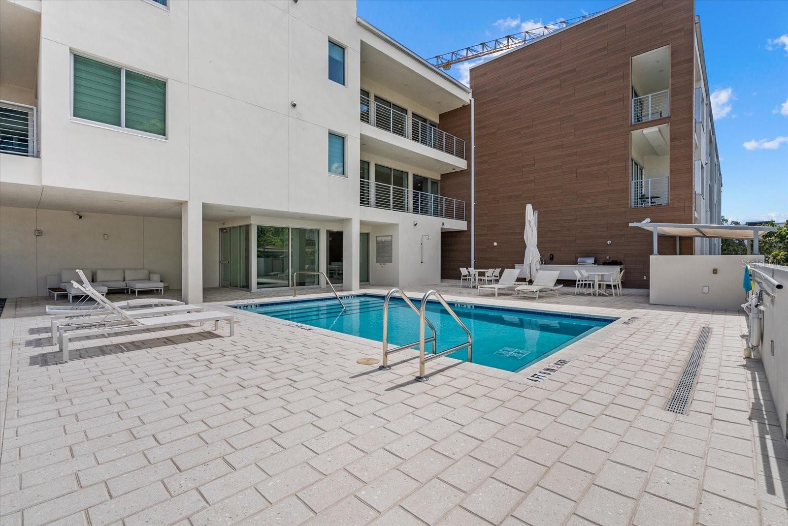 Condominium 332 Cocoanut delivers the ideal blend of modern downtown living and effortless convenience in Sarasota’s vibrant Rosemary District. Offered turnkey furnished, Residence 302 is a beautifully appointed two-bedroom, two-bath condominium designed for those seeking a stylish, low-maintenance lifestyle in the heart of the city. On the third floor, this residence enjoys one of the convenient locations in the building, near the rooftop pool deck and only moments from the elevator and assigned parking space, creating an ease of living rarely found in downtown condominium living. Built in 2021, 332 Cocoanut is known for its contemporary design, intimate feel and relatively low HOA fees. Inside, the residence features thoughtful finishes, modern lighting and an open-concept layout. The spacious primary suite offers a walk-in closet and a private bath, while the guest suite provides comfort and flexibility for visitors or a home office. Residents enjoy a rooftop pool and entertaining area with sweeping city views, all just outside the residence’s front door. In Sarasota’s rapidly evolving Rosemary District, you are surrounded by acclaimed restaurants, cafés, galleries, fitness studios and nightlife, while remaining just moments from Main Street, Sarasota Bayfront, The Bay Park, St. Armands Circle and Lido Beach. Whether you are seeking a full-time residence, seasonal retreat or downtown pied-à-terre, Residence 302 offers a rare opportunity to enjoy accessible luxury with exceptional everyday convenience.