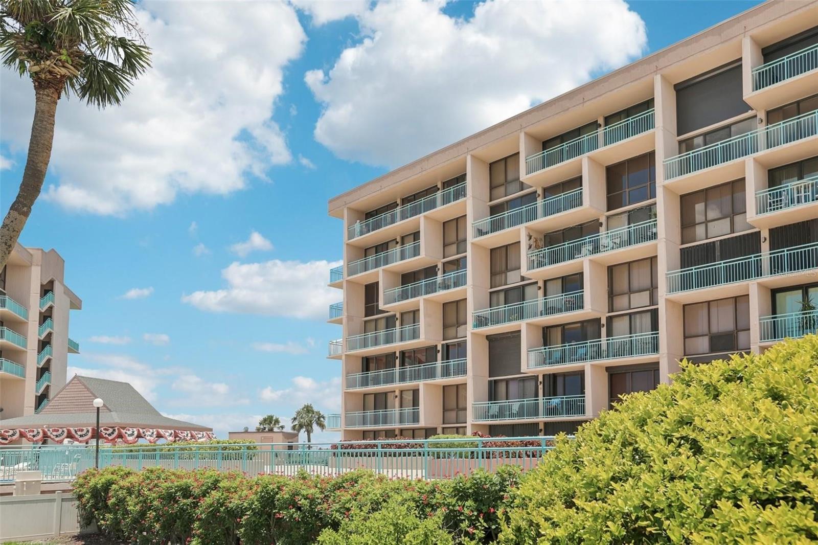 Live the dream in Treasure Island's only gated condo community. This luxurious, resort-style gated community is nestled on the waterfront of Treasure Island, 2-bedroom, 2-bath corner unit in Key Capri offers an unparalleled Florida lifestyle, complete with stunning views and upscale amenities. Step inside to discover an expansive living room flooded with natural light from wall-to-wall, floor-to-ceiling sliding doors that open to a large balcony. Split-bedroom layout ensures privacy, with both bedrooms enjoying beautiful views. The Primary Suite is oversized overlooking John's Pass Village. Ensuite bathroom and walk in closet. The guest bedroom has a spacious closet and floor-to-ceiling sliders overlooking the pool and common areas. Nice kitchen and dining room. Assigned parking in the garage with a personal storage unit. GEOTHERMAL Pool - heated in winter, cooled in summer! Spa, tennis & pickleball courts, tiki bar, putting green & shuffleboard, fitness center & social meeting room, boat slips (leased when available) with direct access to the Gulf & Intracoastal, gated entry and secured entry doors, Enjoy the convenience of being just minutes from Treasure Island Beach, downtown St. Petersburg. Tampa International and St. Pete/Clearwater Airports. Completed both the Milestone Inspection and Structural Integrity Reserve Study, meeting full State compliance. No special assessments! Beautiful updates should be completed in July. Key Capri offers exceptional value: High-Speed Internet-WIFI and Cable TV, Insurance & Flood Insurance, Water, Sewer, Trash, and Reclaimed Water, Secured Gate and Secured Lobby, Landscaping, Heated Pool, Reserves/Building Funds, On-Site Management and Maintenance, Housekeeping and pest control of common areas.