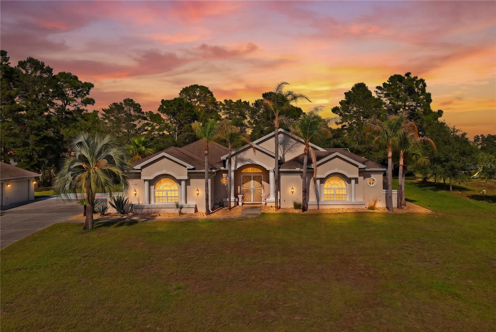 Welcome to the prestigious Woodland Waters community! Discover this truly unique courtyard home — an entertainer’s dream — perfectly designed for comfort, style, and endless gatherings.

Nestled near US-19 and just moments from local attractions like Weeki Wachee Springs, this home offers both tranquility and convenience. Enjoy easy access to grocery stores, shops, and restaurants, all within a short drive.

Step inside to an inviting open-air design where living spaces flow seamlessly around the courtyard. Abundant natural light streams through sliders throughout the home, creating a bright and welcoming atmosphere.

Each bedroom includes its own private bathroom, offering comfort and privacy for family and guests. The one-bedroom in-law suite provides independent living while staying close to the main home.

Outdoors, relax or entertain in the private screened and covered lanai or the spacious outdoor patio overlooking the the secluded property with over an acre of land.

Car enthusiasts will love the oversized three-car garage with a split A/C system and built-in theater room — perfect as a garage or flexible bonus space — plus an additional detached four-car garage for extra vehicles, toys, or workshop space. The large driveway provides plenty of parking for guests.
This remarkable property combines luxury, functionality, and space in one of the area’s most desirable communities.
