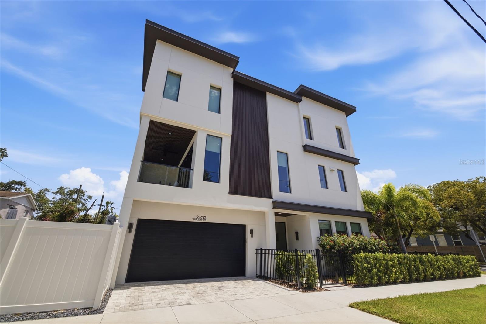 Luxury urban living at its finest. Just three blocks from Armature Works, the Riverwalk, the Straz Center, and some of Tampa's finest dining, entertainment, and nightlife, this exceptional custom townhome offers a lifestyle that's nearly impossible to replicate.

Completed in 2025, every detail was thoughtfully designed to blend modern luxury with effortless everyday living. The chef's kitchen is the centerpiece of the home, featuring custom cabinetry, natural quartzite countertops, premium Thermador appliances, and a gas range that will impress even the most discerning culinary enthusiast. The open-concept design is flooded with natural light through dramatic floor-to-ceiling windows, creating an inviting space that's equally suited for entertaining or relaxing at home.

Step outside to your private outdoor living area, where a covered balcony overlooks one of the property's most remarkable features—your own private saltwater pool. Complete with a built-in grill and outdoor prep area, this space was designed for entertaining and enjoying Florida's year-round lifestyle.

Wide-plank engineered hardwood flooring flows throughout the home, while the stunning floating staircase, showcased behind a full glass wall, creates a striking architectural focal point. The thoughtfully designed floor plan offers a private first-floor guest suite with a full bath, an expansive second-floor living area, and three additional bedrooms with two full baths on the third floor, providing the perfect balance of openness and privacy.  

The expansive primary suite is a true retreat, thoughtfully designed for both luxury and functionality. Wake up to your own private coffee bar before starting the day, then unwind each evening in the spa-inspired en suite bathroom featuring a deep soaking tub, an oversized walk-in tiled shower, dual vanities, abundant storage, and premium finishes throughout. An impressive walk-in closet offers exceptional space for even the most extensive wardrobe, completing a suite that feels more like a boutique hotel than a traditional primary bedroom.

Unlike most urban properties, this home also features a spacious two-car garage, a private side yard ideal for pets or additional outdoor space, and the convenience of low-maintenance townhome living.

Luxury. Walkability. Privacy. Convenience.  This is more than a townhome—it's one of Tampa Heights' most exceptional lifestyle opportunities.