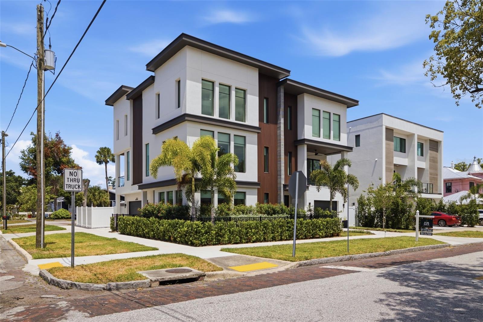Luxury urban living at its finest. Just three blocks from Armature Works, the Riverwalk, the Straz Center, and some of Tampa's finest dining, entertainment, and nightlife, this exceptional custom townhome offers a lifestyle that's nearly impossible to replicate.

Completed in 2025, every detail was thoughtfully designed to blend modern luxury with effortless everyday living. The chef's kitchen is the centerpiece of the home, featuring custom cabinetry, natural quartzite countertops, premium Thermador appliances, and a gas range that will impress even the most discerning culinary enthusiast. The open-concept design is flooded with natural light through dramatic floor-to-ceiling windows, creating an inviting space that's equally suited for entertaining or relaxing at home.

Step outside to your private outdoor living area, where a covered balcony overlooks one of the property's most remarkable features—your own private saltwater pool. Complete with a built-in grill and outdoor prep area, this space was designed for entertaining and enjoying Florida's year-round lifestyle.

Wide-plank engineered hardwood flooring flows throughout the home, while the stunning floating staircase, showcased behind a full glass wall, creates a striking architectural focal point. The thoughtfully designed floor plan offers a private first-floor guest suite with a full bath, an expansive second-floor living area, and three additional bedrooms with two full baths on the third floor, providing the perfect balance of openness and privacy.  

The expansive primary suite is a true retreat, thoughtfully designed for both luxury and functionality. Wake up to your own private coffee bar before starting the day, then unwind each evening in the spa-inspired en suite bathroom featuring a deep soaking tub, an oversized walk-in tiled shower, dual vanities, abundant storage, and premium finishes throughout. An impressive walk-in closet offers exceptional space for even the most extensive wardrobe, completing a suite that feels more like a boutique hotel than a traditional primary bedroom.

Unlike most urban properties, this home also features a spacious two-car garage, a private side yard ideal for pets or additional outdoor space, and the convenience of low-maintenance townhome living.

Luxury. Walkability. Privacy. Convenience.  This is more than a townhome—it's one of Tampa Heights' most exceptional lifestyle opportunities.