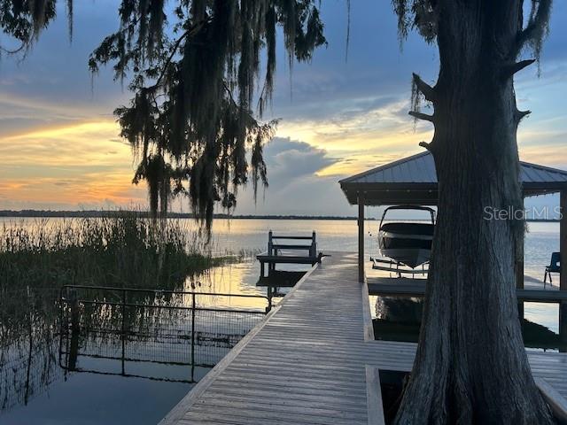 10+ acre site on the Harris chain of lakes, consisting of seven lakes that have approximately +/- 13,788 acres.  It is zone agricultural.  All new deep water well.  Bring your horses and boat! It includes a brand new boat dock, open barn, fence, a deep well, and electricity.  No HOA.  Make it a compound! No impact fees to build.  Build your own custom dream home and add others for family members.  Relax and enjoy spectacular views and sunsets.  This high and dry site has live oaks, palm trees, and plenty of room for a garden.  If you enjoy dining out, take your boat to the many restaurants located on the Harris chain of lakes.  It is located 25 minutes from Orlando and Disney World.  Owner will finance with a small down payment.  This could be yours!