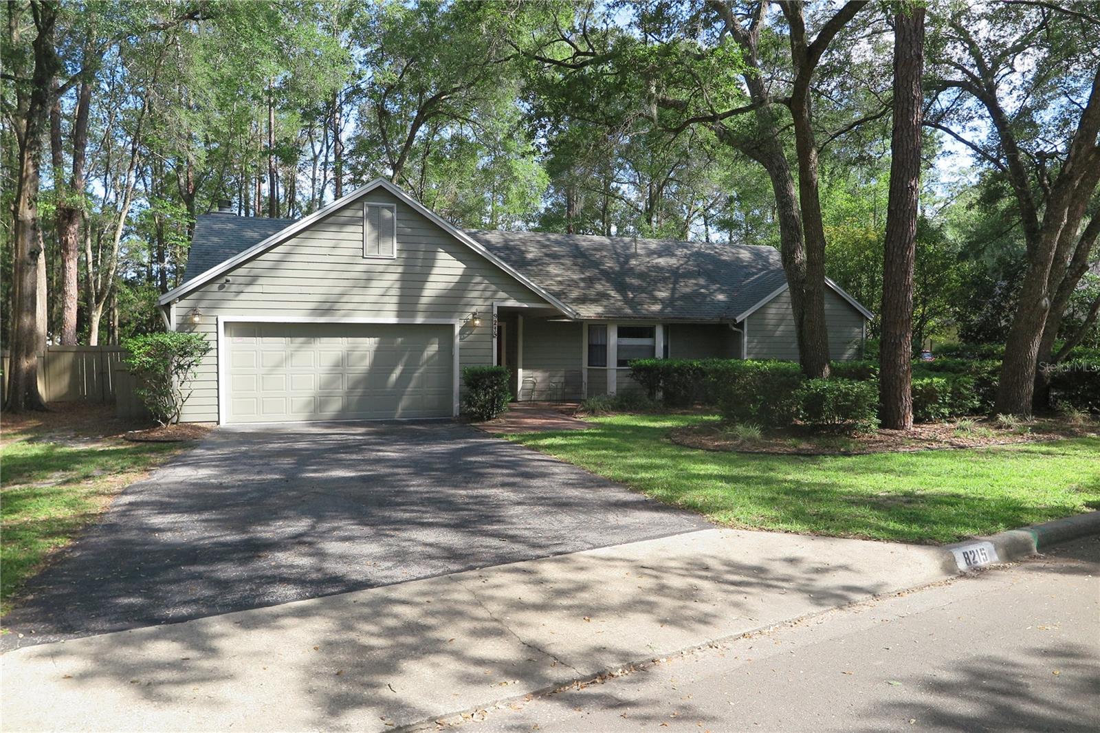 Nestled on a private cul-de-sac in Planters Grove at Haile Plantation, this beautifully updated 4-bedroom, 2-bath residence blends modern upgrades with serene surroundings. Thoughtfully enhanced with renovated bathrooms, luxury vinyl plank flooring, a complete re-plumb, and a tankless gas water heater, the home offers both style and peace of mind.Step outside to an expansive screened lanai overlooking a privacy-fenced backyard that backs to community green space, creating a tranquil retreat with no immediate rear neighbors. Just moments from the Village Center, this exceptional property combines privacy, convenience, and the highly desirable Haile Plantation lifestyle.