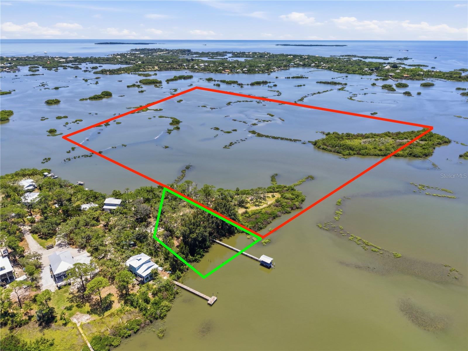 This is a rare opportunity to own the tip of Sunset Point in Cedar Key with nearly 1,000 feet of waterfront and open water views spanning more than 180 degrees. The property totals 41.2 acres, with 1.720 acres of FDEP-approved upland across two separate waterfront lots that together form a natural point surrounded by water on three sides.
Just 400 feet off that point sits your island — reachable by kayak or paddleboard — included in the total acreage and adding another layer to an already exceptional property.
The two lots can be combined into a single estate-sized homesite or held and used separately. Either way, building here means building on pilings — elevated above the marsh, among the twisting branches of the sand live oaks, and oriented toward open water to capture the million dollar views.
An existing dock with a covered platform is on site, accessible by inshore boats at mid to high tide. City water, sewer, and electric are already stubbed to the property. A completed boundary survey with FDEP-approved Mean High Water Line and established Base Flood Elevation are in hand — the preliminary work that typically takes months after closing is already done.
Properties like this don't come back around. The combination of location, acreage, waterfront, and natural character that define Sunset Point simply cannot be assembled from scratch. This is a legacy property in the truest sense — the kind a family holds for generations and never regrets buying.
*Buyers are encouraged to independently verify all building and zoning regulations with Cedar Key, Levy County and applicable regulatory agencies to their satisfaction prior to closing.*