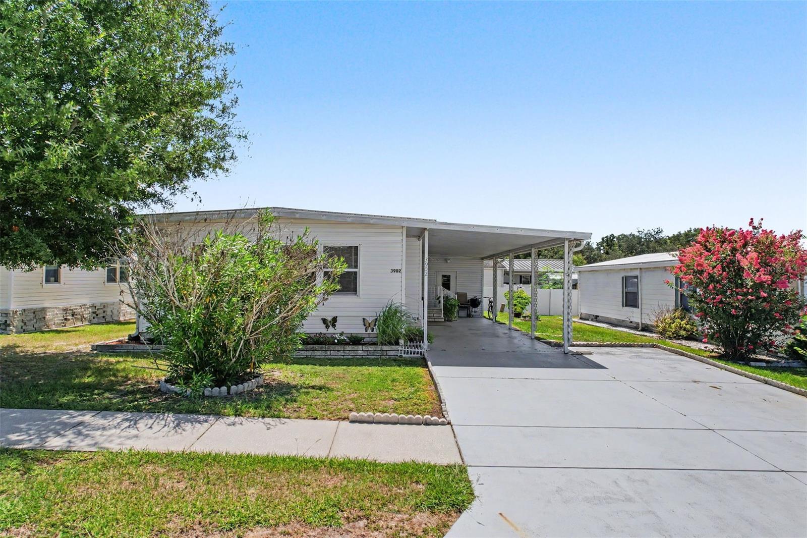Welcome to Terrace Park, a desirable 55+ community where you own the land and can enjoy the community pool for more enjoyment. This well-maintained home offers numerous upgrades and features designed for comfortable Florida living.  The roof was replaced in October 2020. The kitchen features upgraded cabinetry, new laminate flooring, newer appliances, creating a functional and attractive space for everyday living.  Enjoy a morning coffee in the enclosed front porch (newly renovated and insulated to prevent the heat.  The primary bedroom is privately situated in the rear of the home and features a walking closet and renovated bathroom.  The second bedroom generously sized and offers built-in closet for ample storage with a fully renovated bathroom just across the hallway.  Convenient laundry facilities located in the attached utility room with built-in shelves for additional storage, just off the carport.  Outside you have plenty of room for vehicles and guests.  !!!!!!!Schedule your private tour today and discover all that this wonderful home has to provide.  Homes in Terrace Park don't stay on the market long!!!!