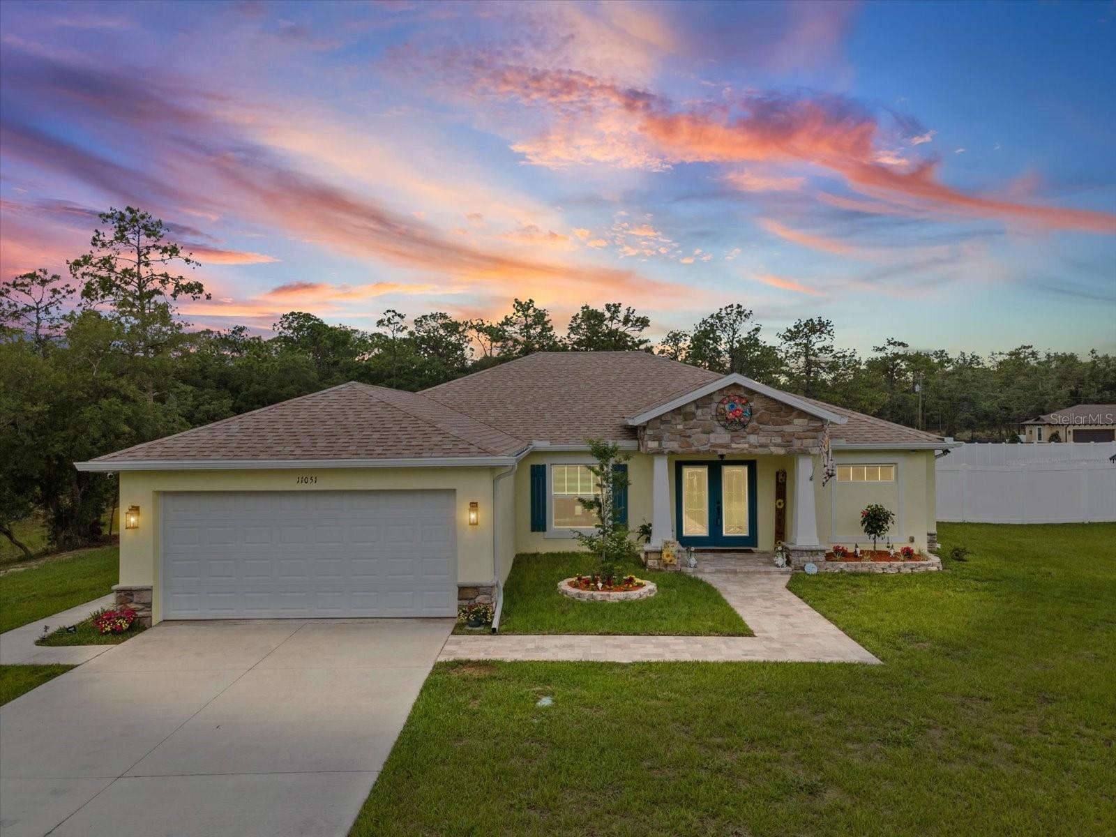 Amazing pool home built for the buyer who refuses to settle for cookie-cutter! This fully loaded custom-modified Palmwood Concord 5 delivers the kind of lifestyle people scroll for endlessly online but rarely find in real life. Nestled on 1.10 fully fenced and cross-fenced acres, this showstopper offers space, luxury, functionality, privacy, and a setup that’s hard to find all in one property.
From the moment you pull in, this property makes a statement. The extra-long driveway, electronic gated rear entrance, massive garage/workshop, RV and boat storage, and fully equipped hookups for your RV with 30/50 amp electric, sewer, and water instantly set this home apart from the rest.
Inside, the vibe is modern luxury with just the right amount of warmth. Soaring tray ceilings  upgraded lighting, recessed lights, and zero carpet create a clean, elevated feel throughout. The kitchen is absolutely beautiful. Featuring upgraded soft-close cabinetry with crown molding, granite countertops throughout, Café appliances, a gas range, custom vent hood, oversized island, and all the prep and entertaining space you could ask for, this is the kind of kitchen people gather in and never want to leave.
Then the entire back of the home opens up with a triple slider that fully retracts, blending indoor and outdoor living seamlessly. 
Your private backyard retreat was built for unforgettable nights and lazy Florida weekends. Heated pool and spa? Check. Sealed pavers? Check. Full surround sound flowing onto the patio? Of course. Propane hookup already waiting for your future outdoor kitchen? Already done. Footers are even poured for a future screened enclosure, making it easy to take this outdoor setup to the next level.
And just when you think it couldn’t get more versatile… there’s a private mother-in-law suite with its own exterior entrance, interior access with pocket door separation, kitchenette, bedroom, and full bath. Perfect for multigenerational living, long-term guests, or creating the ultimate “don’t bother me” retreat.
The primary suite brings the luxury too, with his-and-her walk-in closets and a spa-like feel throughout, the en suite. The guest bathroom features a deep soaking tub perfect for winding down after long days.
Need workspace? Hobby space? Business space? The detached office house is fully equipped with high-speed fiber optic internet and its own mini-split heat pump, making working from home feel a whole lot less like working. The huge workshop/garage has dedicated 150 amp service off the 400 amp panel, giving you serious flexibility for toys, tools, projects, or equipment.
And yes… there’s even an adorable chicken coop because this property somehow manages to combine luxury living with just the right touch of country charm.
With tankless water heater, gutters, sealed pavers, exterior eave outlets for lighting, upgraded finishes throughout, and flexible living spaces including a 5th bedroom perfect for an office, gym, or flex room, this isn’t just a home. It’s the kind of property people wait for.