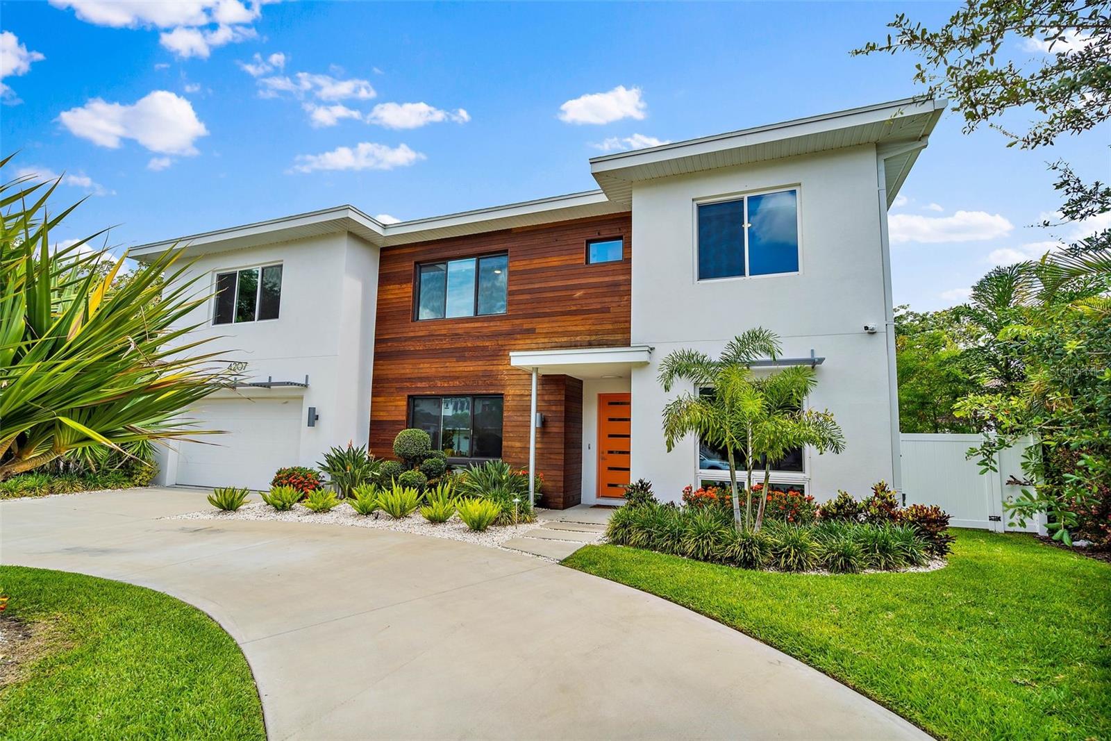 Welcome to 4207 W. Jetton Ave, a stunning contemporary home located in the Culbreath Heights neighborhood of Tampa, Florida. This exquisite property was built in 2020 and boasts a multitude of features that cater to modern living. With 5 bedrooms, 4 bathrooms, a media room, an office, a 2-car garage, and a pool in the backyard, this home offers both style and functionality. Situated on an oversized lot, the property provides ample space for outdoor activities and features stunning landscaping. As you step inside, you'll be greeted by a beautiful
sitting area to the left offering a cozy space for relaxation. Adjacent to this area, you'll find a dry bar and a pantry, granting easy access to the kitchen and ensuring convenience during gatherings and meal preparations. The open-concept lower level (which boasts hardwood floors) seamlessly combines the kitchen, dining room, and living room. The kitchen is a true highlight, featuring a spacious layout, Quartz countertops with a waterfall edge, and European-style flat panel wood cabinets wrapped with white acrylic. The large kitchen island serves as a focal point and is complemented by Bosche stainless steel appliances, an integrated refrigerator, floating oak shelves, and under-counter LED lighting. If that wasn't enough, the first level of the home also features a dedicated office, an inlaw suite with a full bath (which conveniently doubles as a pool bath), and hurricane impact sliding glass doors letting in plenty of natural light and creating an elegant and
airy ambiance leading to the backyard. Ascending the floating steel staircase, you'll discover the bedrooms on the second floor. High ceilings are a staple throughout the home. The luxurious main bedroom is sure to impress with a large panoramic window, two walk-in closets (with custom shelving), and direct access to the extraordinary en-suite bathroom. Here you'll find floating dual Quartz vanities, under-counter lighting, a frameless glass walk-in shower, and a solid vessel soaking tub. The designer wall and floor tiles further enhance the visual appeal
of the space. The rest of the second-floor features three additional bedrooms and two full bathrooms, along with a media room, perfect for having guests over for movie night. This residence is equipped with various modern amenities, including a tankless water heater, natural gas, a whole-home water filtration system, and a water softening system. Additional features include impact windows and doors, two 15 SEER HVAC systems, and 8' solid interior doors to ensure comfort and efficiency. The property also comes with a 2-car garage, a large laundry room, pre-wired security, and a remote video doorbell. The outdoor area is perfect for entertaining and relaxation, featuring a pool, a covered patio, and an outdoor kitchen. Whether you want to cool off in the pool or host a barbecue with friends, this backyard oasis offers endless possibilities. Location is key, and this home offers easy access to Downtown Tampa, Tampa International Airport, I-275, and the Westshore District, while also being situated in the Plant High School District. Don't miss the opportunity to make 4207 W. Jetton Ave your
dream home, where contemporary design, luxurious features, and convenient location seamlessly merge to create a truly exceptional living experience.