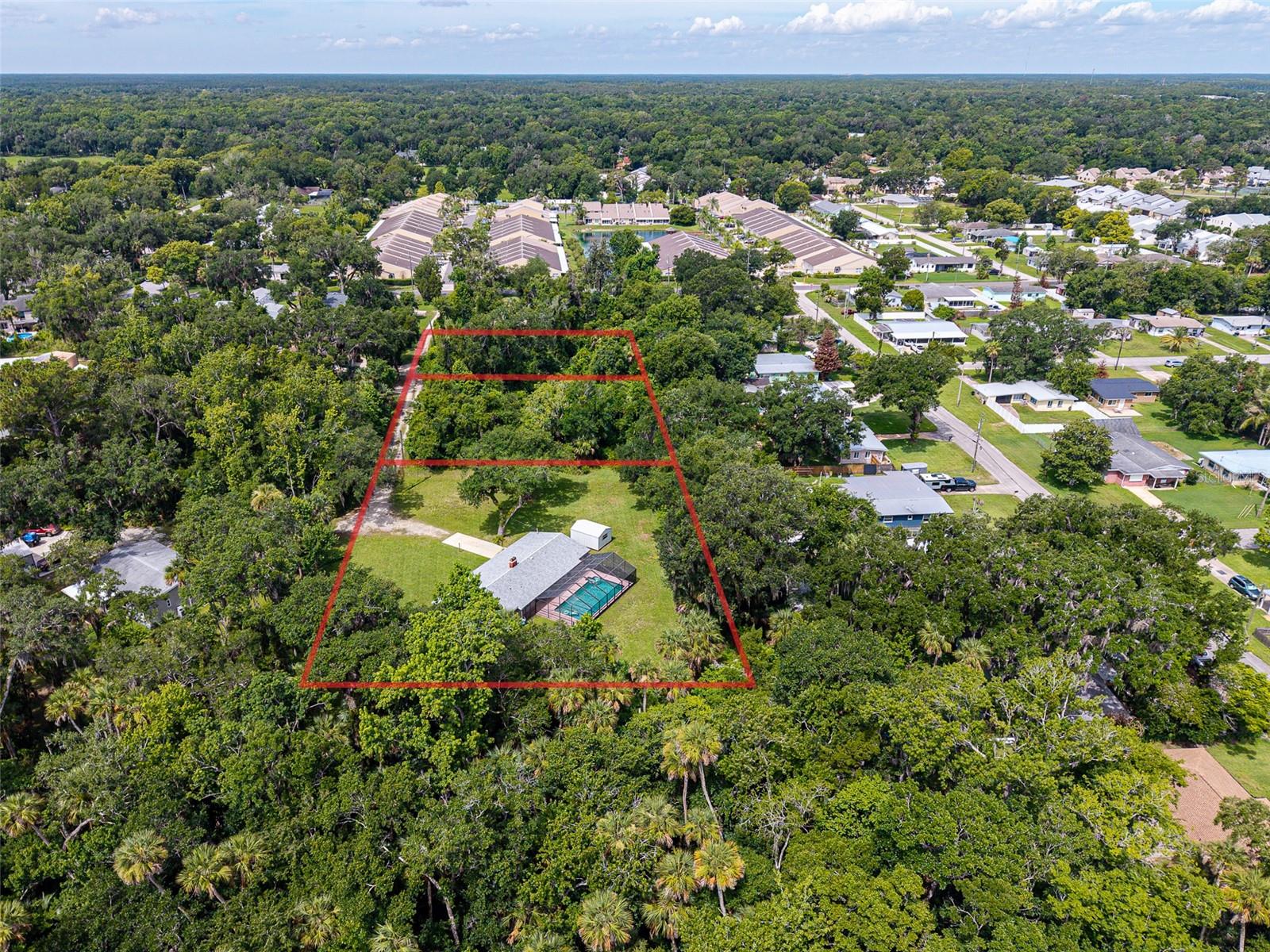 Escape to your own private paradise with this updated 3-bedroom, 2-bath pool home situated on three separate parcels totaling 2.36 acres. Offering the perfect blend of privacy, space, and convenience, this property allows you to enjoy peaceful country-style living while remaining just minutes from shopping, dining, and the area's beautiful beaches. Inside, you'll find a thoughtfully renovated interior featuring luxury vinyl flooring throughout, elegant plantation shutters, and a new kitchen complete with quartz countertops and modern finishes. Multiple living spaces, including a spacious living/dining area and a separate family room with a wood burning fireplace, provide plenty of room for entertaining, relaxing, or accommodating a growing family. Step outside and enjoy Florida living at its finest in the screened 16' x 32' pool area, perfect for year-round enjoyment. The convenient pool bath makes outdoor entertaining effortless, while the expansive acreage offers endless possibilities. With two additional parcels included, you'll enjoy added flexibility and room to build an additional home, guest house, workshop, or other future improvements (subject to local approvals). Major updates provide peace of mind, including a new roof (2019), new A/C system (2023), and new water heater (2023). Seller notes, built with durable concrete block construction, this home is designed for lasting value and low maintenance. Additional features include a spacious 15' x 26.5' garage, storage shed, and best of all NO HOA restrictions, giving you the freedom to truly make the property your own. If you've been searching for a move-in-ready home with acreage, a pool, modern upgrades, future building potential, and a prime location close to everything, this exceptional property delivers it all.