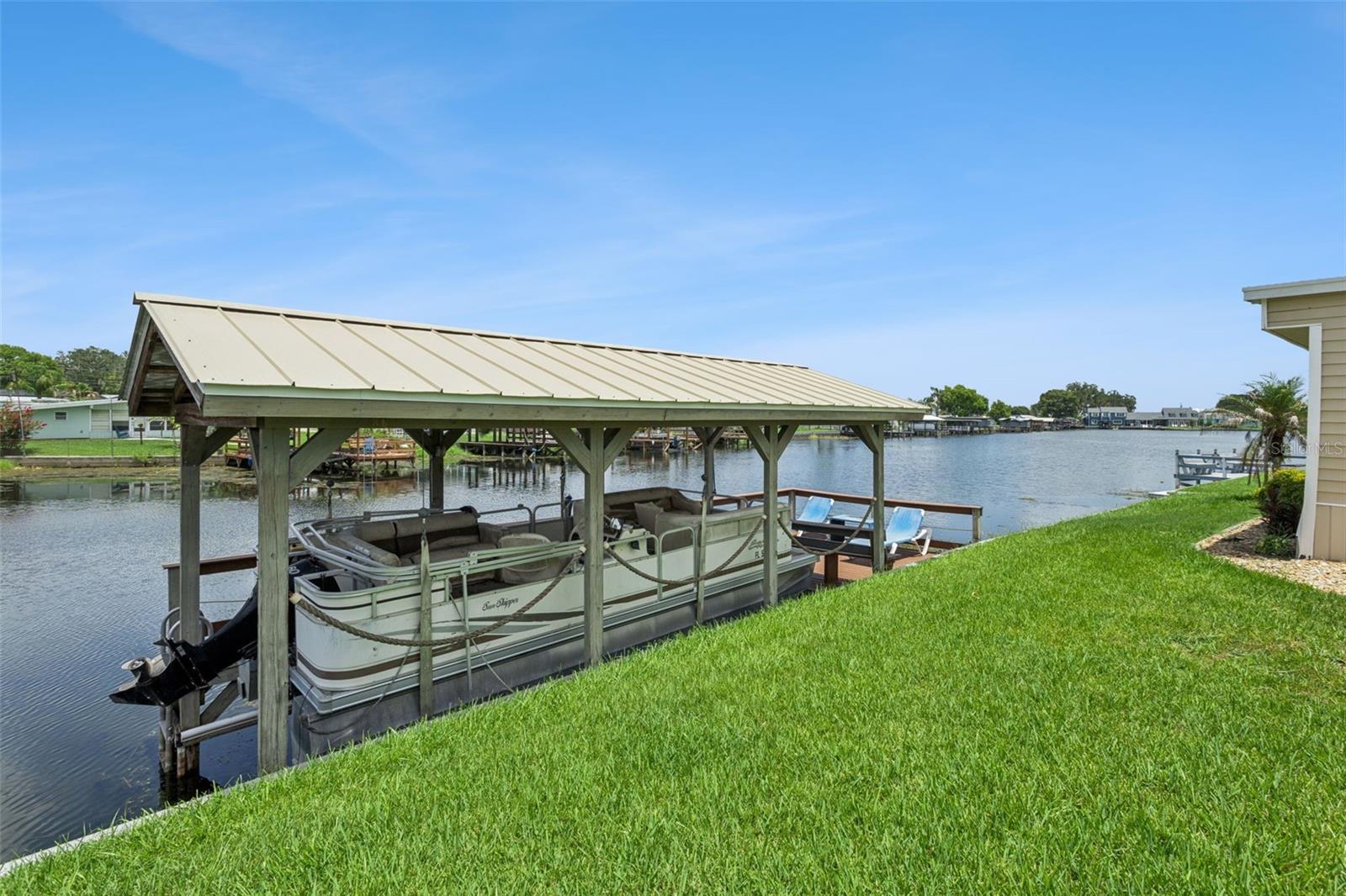 Waterfront living with direct canal frontage and beautiful views of Lake Dora and NO HOA! This well maintained 1972 mobile home, situated on a cul de sac has been successfully operated as a vacation rental and offers a spacious layout designed for relaxing and entertaining. Enjoy indoor - outdoor living with two screen patios, providing the perfect spaces for morning coffee, evening sunsets, or gathering with guests. The home features generously sized bedrooms, an inviting living area, and a large primary suite with walk-in closet. Outside, you'll find a private dock with a boat lift, allowing easy access to the Harris Chain of Lakes for boating, fishing, and waterfront dining adventures. With no HOA this home offers flexibility as a primary residence, seasonal retreat, or investment opportunity. Located in a charming waterfront community, this is your chance to enjoy the laid back Florida lifestyle with canal frontage, lake views, and endless recreational opportunities right from your backyard. Ideally located near shopping, dining, grocery stores, and AdventHealth Waterman Hospital, this home also offers convenient access to US-441 and SR-19. Enjoy nearby waterfront festivals, entertainment, and year-round events in Tavares and Mount Dora, while Orlando's world-class attractions and Orlando International Airport are approximately an hour away.