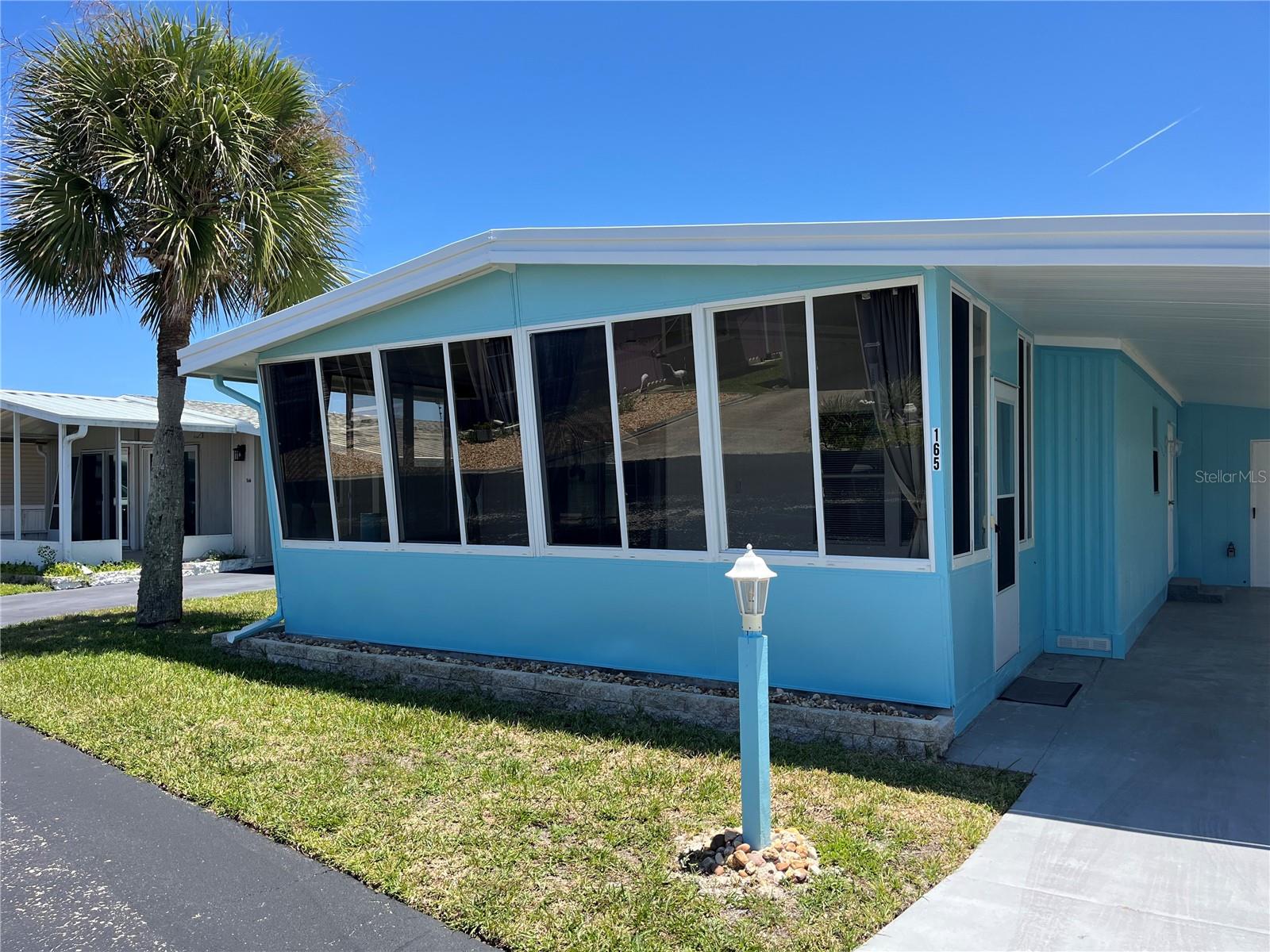 If you are looking to enjoy the beach this summer, don't miss this updated, move-in-ready 2-bed/2-bath bungalow located across the street from the ocean! This home features an open floor plan, a newer kitchen with modern appliances, and luxury flooring throughout. Both bedrooms are spacious with ample storage, and both bathrooms include walk-in showers. For those who love to host, the large enclosed front porch provides significant additional entertaining space. The property includes a long driveway with room for two cars, golf cart parking, and a large storage room with built-in cabinets. Professional upgrades completed in June 2026 included a new water heater, new subfloors, and new ductwork. Additionally, the metal roof has been professionally cleaned and coated with Lanco Ultra Siliconizer, and the exterior has been freshly painted. Located in Surfside Estates, an active 55+ manufactured home community nestled between the Atlantic Ocean and the Intracoastal Waterway, this is a Resident Owned land share community with no lot rent. Your purchase includes a share of the community, and the $220 monthly maintenance fee covers; High-speed Wi-Fi, internet, and cable, yard maintenance and access to all facilities, including a heated/cooled pool, fitness room, library, shuffleboard, and a rooftop deck. The Social Club offers a vibrant lifestyle with Friday night bingo, card games, water aerobics, and a large screen TV for sporting events. You can walk to the beach, or take a golf cart to the community docks to fish as you watch the dolphins. The community also features kayak storage, a BBQ pit, and a gazebo overlooking the Intracoastal. With the quaint shops and restaurants of Flagler Beach just minutes away, and essential shopping and hospitals located just over the bridge, everything you need is within reach. What are you waiting for? Your relaxed beach lifestyle is waiting for you!