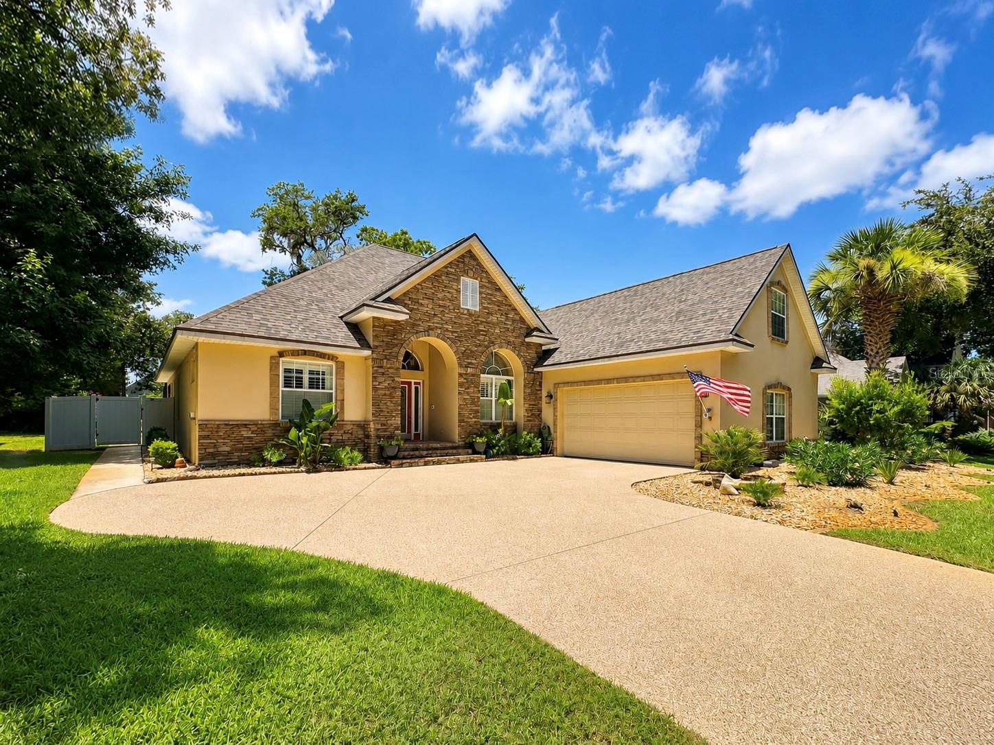 Welcome Home to this immaculate 4-bedroom, 3-bathroom solid concrete block pool home, perfectly situated in a beautiful gated community of Fairchild Oaks with tree-lined streets and a peaceful park-like setting. Meticulously maintained and move-in ready. Set high and dry, this exceptional residence offers comfort, quality, and timeless appeal. New Roof and HVAC 2023. Designed with both privacy and functionality in mind, three of the four spacious bedrooms feature en-suite bathrooms, while rich cherry wood flooring adds warmth and elegance throughout the bedroom spaces. Sound buffering luxury plank flooring over ceramic tile gives function for today with flexibility for the future. Soaring 15 foot ceilings in the living room and dining room and 12 foot throughout. Oversized four panel stacking sliders bring the outdoors inside and elevate the space. At the heart of the home, the expansive kitchen boasts custom wood cabinetry, granite countertops, stone backsplash, newer appliances, abundant storage, including pot drawers. Craftsman range hood and integrated plate rack. Generous workspace and breakfast bar making it ideal for both everyday living and entertaining. Separate family room/den is complete with cosy gas fireplace and walk out patio/lanai French doors. Plantation shutters adorn the windows from room to room.  Step outside to your private backyard oasis, where the enclosed pool and heated spa are the main attraction. Screened enclosure, and inviting lanai, and roller shades create the perfect outdoor living space for all year long. Primary suite is a true retreat with slider patio access, walk-in closet, linen closet, and en-suite featuring dual separate vanities, a spacious walk-in tiled shower, and a relaxing garden tub perfect for unwinding after a long day. Elite driveway and garage coating with warranty. Plus brand new cool touch technology rubber pool deck surfacing. Artificial turf pet relief area, and minimal maintenance backyard landscaping design. This home combines quality construction, thoughtful design, and an unbeatable location in one of the area's most desirable communities. Conveniently located near shopping, dining, parks, schools, and the beautiful beaches, this is Florida living at its finest.
