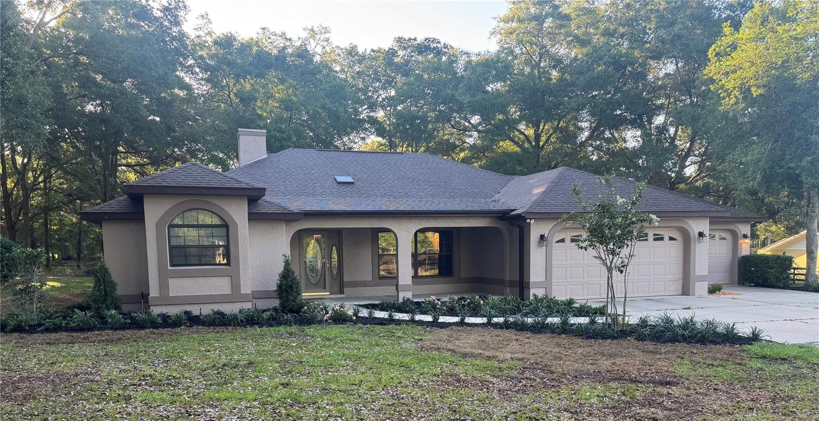 Beautifully renovated 3-bedroom, 2-bath pool home situated on 3 private acres, offering the perfect blend of modern comfort and country charm. This open-concept floor plan features a stunning updated kitchen with custom wood cabinetry, quartz countertops, and stylish finishes throughout. New wood flooring flows seamlessly through the home, complemented by beautifully remodeled bathrooms and abundant closet space for storage. Enjoy relaxing views from the air-conditioned rear sunroom overlooking the sparkling pool and peaceful acreage beyond. Car enthusiasts, hobbyists, and farm owners will appreciate the oversized 3-car garage with a unique drive-through design, ideal for easy access to equipment, trailers, or recreational vehicles. Outside, a spacious workshop offers endless possibilities and can easily be converted into a two-stall barn for equestrian or agricultural use.Located in a desirable neighborhood directly across from the World Equestrian Center, this property offers an easy commute to equestrian events, horse shows, and year-round activities. This move-in-ready home combines updated living with functional outdoor space, making it ideal for those seeking privacy, flexibility, and convenient access to one of Ocala’s premier destinations.