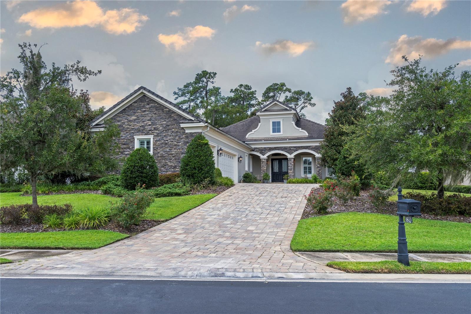 On a quiet street, atop a hill sits this lovely home with a phenomenal view of Golden Ocala's "Postage Stamp" Tribute Hole. An expansive great room features a dream kitchen with gas cooking and a built-in wine refrigerator. A wall of glass doors opens to the lanai with a summer kitchen and fireplace and the glorious view beyond. The lanai has automatic drop-down screens. All three bedrooms are ensuite plus a half bath for visiting guests. A large three car garage provides ample parking. A golf cart ride will take you to all of Golden Ocala's many amenities including direct access to World Equestrian Center. Featuring a wonderful floorplan on one of the finest lots in Golden Ocala, this home is a rare opportunity.