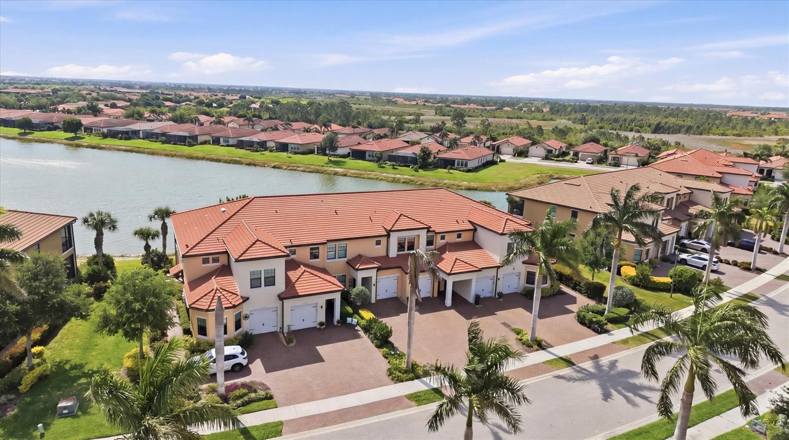 FANTASTIC LAKE VIEW. Watch the SUNRISE over the water and enjoy sitting on your PEACEFUL LANAI. Lots of bird wild life. Open great room floor plan combines living area, kitchen, and dining room in an elegant yet functional design.  Kitchen offers updated GORGEOUS GRANITE COUNTER TOPS. STONE BACKSPLASH, 42 IN CABINETRY, STAINLESS STEEL APPLIANCES,  PENDANT LIGHTS,  RECESSED LIGHTING, HUGE ISLAND INCLUDING SINK.  FABULOUS for entertaining, casual get together's, or a quiet evening at home.  TILE flooring throughout the main areas with carpets in bedrooms. CROWN MOLDING. PLANTATION SHUTTERS on windows  Master bedroom has brand NEW CARPET,  FRESH PAINT..  En suite bath offers dual sinks, walk in shower, and walk in closet.  Guest bedroom and bath on the other side of condo for privacy.  Both bathrooms have Granite counters, tile to ceiling in showers with decorative listello, rain shower heads and safety bars. GENEROUS SIZED laundry room with storage cabinets and extra storage space.  DON'T MISS OUT ON THIS MAGNIFICENT OPTION.  SEE IT TODAY!!  Some furniture available for separate purchase.  Sarasota National is a VIBRANT AND ACTIVE community with over 1300 acres designated for preservation, conservation, lakes, and open space with amazing views, Proclaimed as an Audubon International Certified Sanctuary, making it the most gorgeous and enjoyable golf course to play at in the area. Offering resort style amenities with huge resort style pool and spa,Tiki Bar to serve refreshing drinks and a bite of lunch, tennis courts, pickle ball, Bocce courts, coffee lounge/library/card room/meeting place, 7000 sq ft fitness facilities offering classes and day spa, and a 30,000 sq ft Clubhouse with dining and spectacular views. 18 Hole championship golf course surrounded by native wetlands and preserves provides an exhilarating and dramatic back drop for your golfing adventure. Minutes away from the new Wellen Park shopping area and Atlanta Braves stadium. Venice Beach and Venice Downtown are just a short drive. Your choice of restaurants and outdoor activities await.