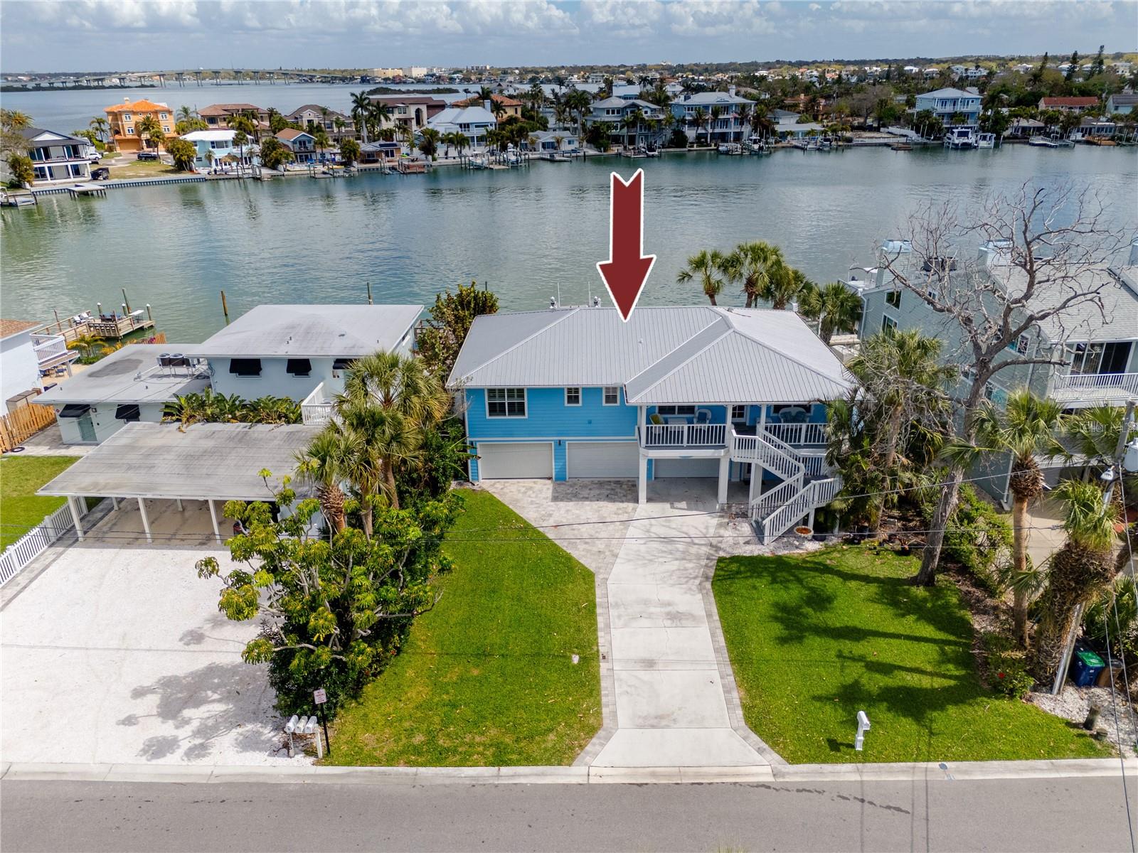 The only elevated waterfront home available in Indian Rocks Beach under $2M! This rare opportunity features 3 bedrooms, 2 baths AND 73 feet of Intracoastal water frontage. Perfectly positioned on a calm inlet, this property is a boater’s dream, equipped with a updated private dock and a 9,000lb lift keeping your vessel ready for sunset cruises or offshore fishing in the Gulf at a moment's notice. Designed for both relaxation and resiliency, the home boasts an expansive covered rear deck perfect for your morning cup of coffee or evening cocktails and an oversized hot tub with panoramic water views. A paver walkway, firepit, and alfresco dining area round out a backyard built for enjoyment. Inside, the 1,624 square feet of elevated living space is designed to keep the water front and center. Multiple French doors open the rear of the home to the deck, engineered hardwood floors carry through the main living areas, and the kitchen anchors the open-concept space with solid surface counters, updated appliances, and an easy flow into the dining and living rooms. Plantation shutters, updated lighting, and newer ceiling fans throughout give the interior a clean, coastal finish. The primary suite sits upstairs with a walk-in closet and serene inlet views. The ground level combines a two-car garage with additional storage space . Perhaps most importantly, this home remained high and dry through recent hurricanes, and it carries an assignable flood insurance policy at approximately $900 per year, a number that speaks for itself on an Intracoastal address in Pinellas County. The investment profile is equally clear. No HOA, no minimum lease period, a metal roof, a seawall updated in 2019, and a proven short-term rental history with projected annual revenue of $90,000 or more. A few blocks to the sand, dining, and shops along Gulf Boulevard, with easy access to Clearwater Beach and the broader Indian Rocks corridor. Don’t miss this low-maintenance, move-in-ready beach house in one of Pinellas County’s most sought-after golf-cart-friendly communities.