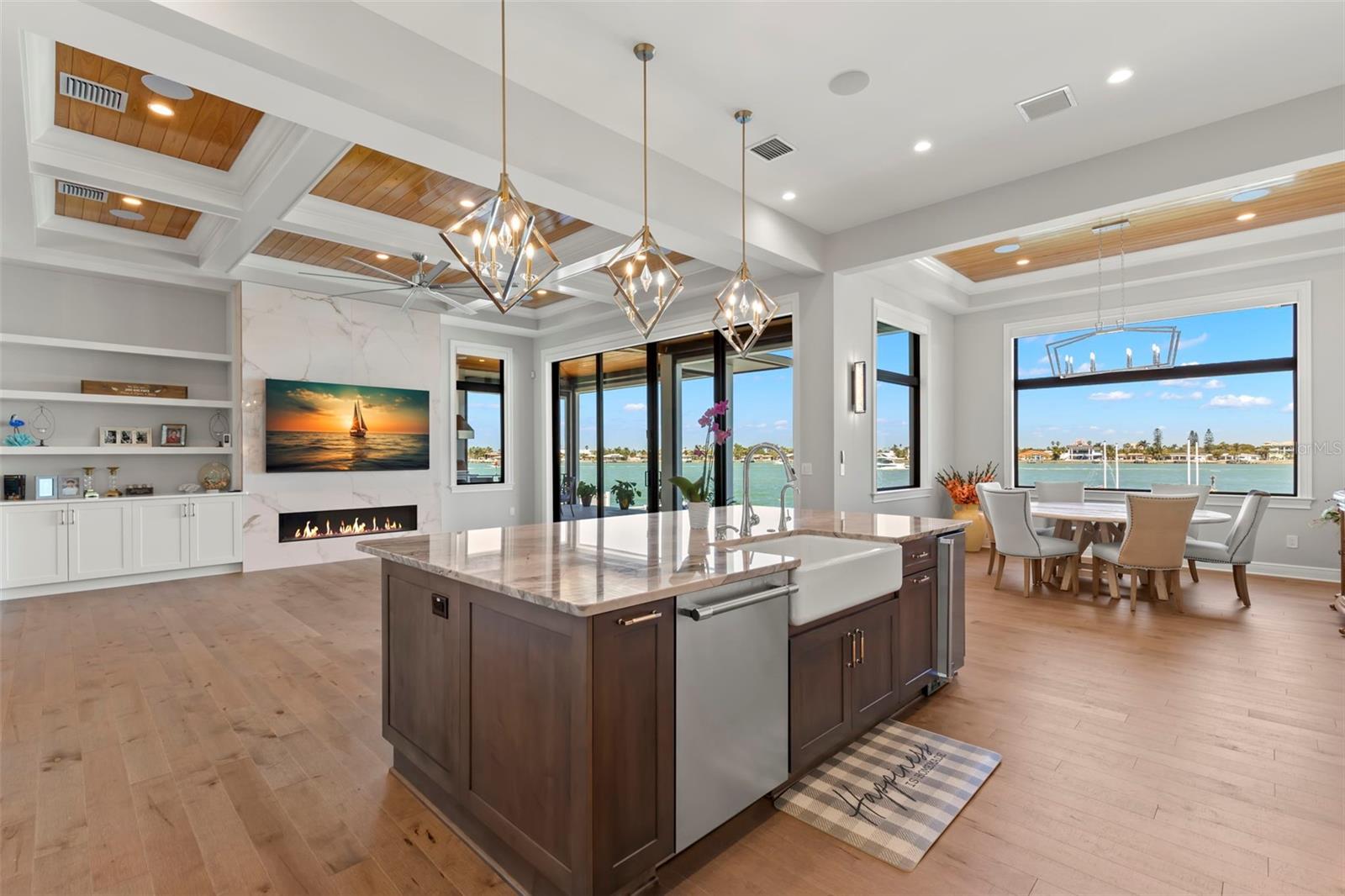 Presenting a stunning waterfront masterpiece in Tierra Verde, Florida, custom built in 2022 by Alvarez Homes. This exceptional property is a true coastal gem, designed to maximize open water views and offer a luxurious yet inviting lifestyle tailored to modern needs. From the moment you arrive, the coastal contemporary design and meticulous attention to detail including Zosia grass lawn, will capture your imagination. Step inside to discover an open floor plan with high 12 ft volume ceilings and exquisite coffered ceiling details, complete with tongue and groove wood inlet. Every corner of this home exudes quality, featuring wide plank hardwood flooring and level 5 flat texture walls and ceilings. The main living level hosts a spacious primary suite, complete with a sizable walk-in closet featuring a custom closet system and a luxurious primary bath showcasing spectacular large dimension marble slabs, a walk-in frameless glass shower, separate soaking tub, separate vanities, and a private water closet.
In addition to the primary suite, the main living level includes a large laundry, a separate butler pantry with ample storage, a second bedroom suite, perfect for guests or multi-generational living, and an office. As you ascend to the second living level (easily accessed with the elevator), you'll find two spacious waterfront bedrooms with walk-in closets, en suite baths, beautiful covered waterfront terraces, and an upper loft living area, creating a perfect space for relaxation and leisure. The waterfront amenities of this property are equally impressive, featuring a newer seawall and a 38.7 X 10 ft dock with a lift system. The outdoor living areas on this expansive lot are a true paradise, boasting an enormous pool with firepot accents, a swim shelf, jacuzzi, and an outdoor kitchen, creating the perfect setting for al fresco dining and entertaining.

This well-built exemplary residence offers "green build" features, the best hurricane ratings, an elevator, a generator, motorized outdoor screens, motorized blinds throughout, designer lighting, and so much more. With 4 bedrooms, 4 1/2 baths, plus an office, this exceptional waterfront residence seamlessly combines luxury, functionality, and coastal charm. Don't miss this opportunity to have it all!