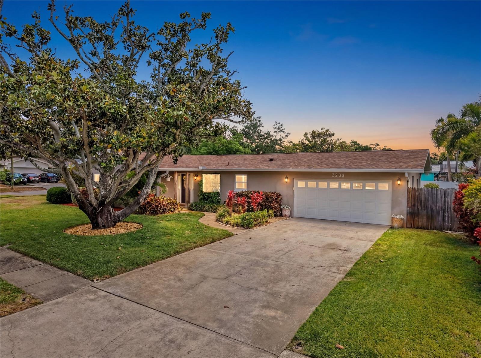 Welcome to this beautiful, oversized corner lot, situated in a non-flood, non-evacuation zone. This spacious two-bed, two-bath, two-car garage home is located in the highly sought-after neighborhood of Morningside-Meadows. Enjoy the charm of a highly walkable neighborhood that fosters connection, community, and an inviting atmosphere for all ages. This meticulously kept home was renovated in 2017 and then made weather-ready with heavy-duty impact-resistant PGT windows throughout the house and a brand-new roof in 2024. The home features an open-concept layout, giving it a large, roomy feel. The interior has updated bathrooms, and the kitchen is a chef’s delight accentuated by a large island and modern appliances. This home comes with an irrigation system fueled by an endless supply of water from its own private well, as well as a whole-house water softener. With a backyard that is oversized compared to others in the area, this house offers an outdoor retreat with room to create your dream oasis. As a bonus, this sought-after community features the gorgeous, newly renovated Morningside Recreation Center close by. The Recreation Center provides all the amenities you could ask for, with a well-equipped fitness center, an Olympic-sized swimming pool, a smaller kiddie pool and splash pad, and ample basketball, pickleball, and tennis courts. Located in the heart of Pinellas County, Tampa International Airport, St. Petersburg, Dunedin, Safety Harbor, and Clearwater Beach are within a proximity of less than 20 minutes. Participation in the Morningside-Meadows HOA is optional.