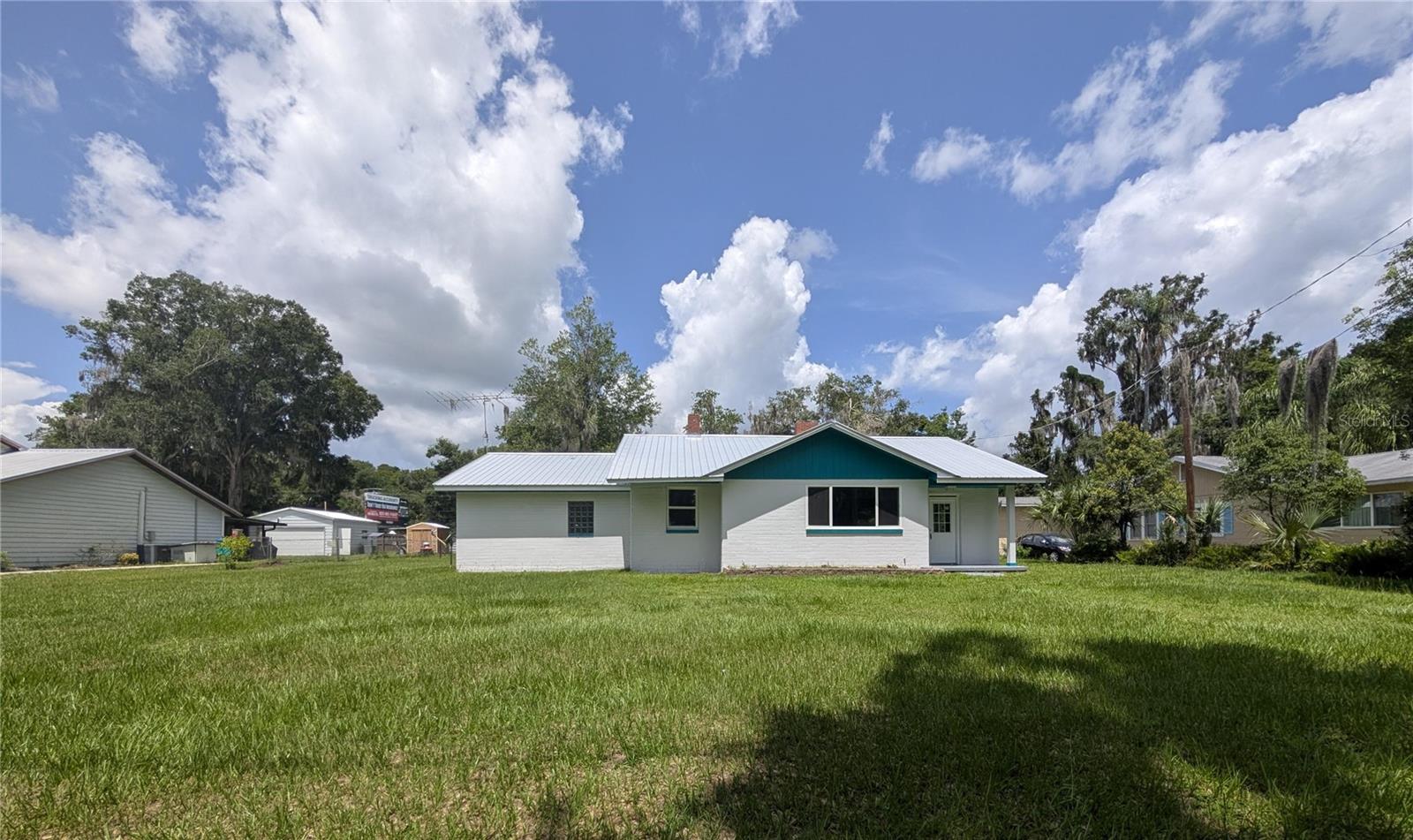 Overlook Crescent Lake through luminous picture windows in this 3 bedroom, 2 bath, newly remodeled concrete brick home. From the views of the lake, to the peacocks, to the old Florida meets modern feel, this home has much to offer. This home has a new metal roof, a sizeable kitchen with significant amount of counter space, 2 Lazy Susans, glass mosaic tile wall, stainless steel appliances with a stainless-steel drop-in design kitchen sink with a high-arc faucet. The living room invites you with a wood-burning fireplace, picture windows and Low-E glass (saving you money on heating and cooling as well as window condensation). The primary bedroom has a spacious en-suite bathroom with beautiful glass mosaic tile in the shower and bonus rooms perfect for an office, closet or nursery. Throughout the home is vinyl plank flooring and there is another bonus room perfect for a playroom, office or even a 4th bedroom. The generous sized mudroom has a wall chalkboard and washer/dryer hook-ups. Outside there is a concrete slab ready for your new garage or workshop to be built. Seller is giving a $1,500.00 credit to buyer at closing for refrigerator/appliances. This home is located less than a quarter mile to Eva Lyons Park, Margary Neal Nelson Sunrise Park and public boat ramp, less than a mile to Crescent City public boat ramp, 3 Bananas Restaurant, Ace Hardware and Lake Stella. Slightly over a mile to shopping, parks, fine dining and fast food restaurants, doctors offices and Middleton-Burney Elementary School. Less than an hour to Ormond Beach, "World Famous" Daytona Beach, St. Augustine, Salt Springs, Palm Coast, Flagler Beach, Crescent Beach, and World Golf Village. Orlando, Jacksonville, Gainesville and Ocala are less than an hour and a half away.