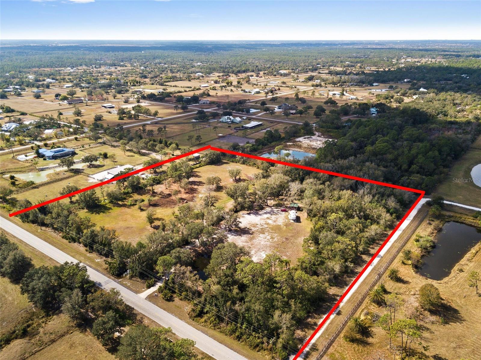 Price Improvement! Panther Ridge build-ready land with improvements already in place! This scenic parcel features added fill dirt creating a solid, elevated homesite ready for construction. A private pond adds both natural beauty and functionality, while a charming wooden bridge provides access across the property. Mature trees offer privacy and a peaceful rural setting, with open areas ideal for building, recreation, horses, or a small homestead. The land is partially cleared with usable space already established, saving future owners time and upfront development costs. Whether you envision a custom estate, barndominium, equestrian retreat, or weekend getaway, this property offers endless possibilities in a quiet natural setting. Located within the highly desirable Panther Ridge community, residents enjoy access to scenic riding and walking trails throughout the neighborhood. Bring your builder and your vision — this exceptional property is ready for its next chapter.