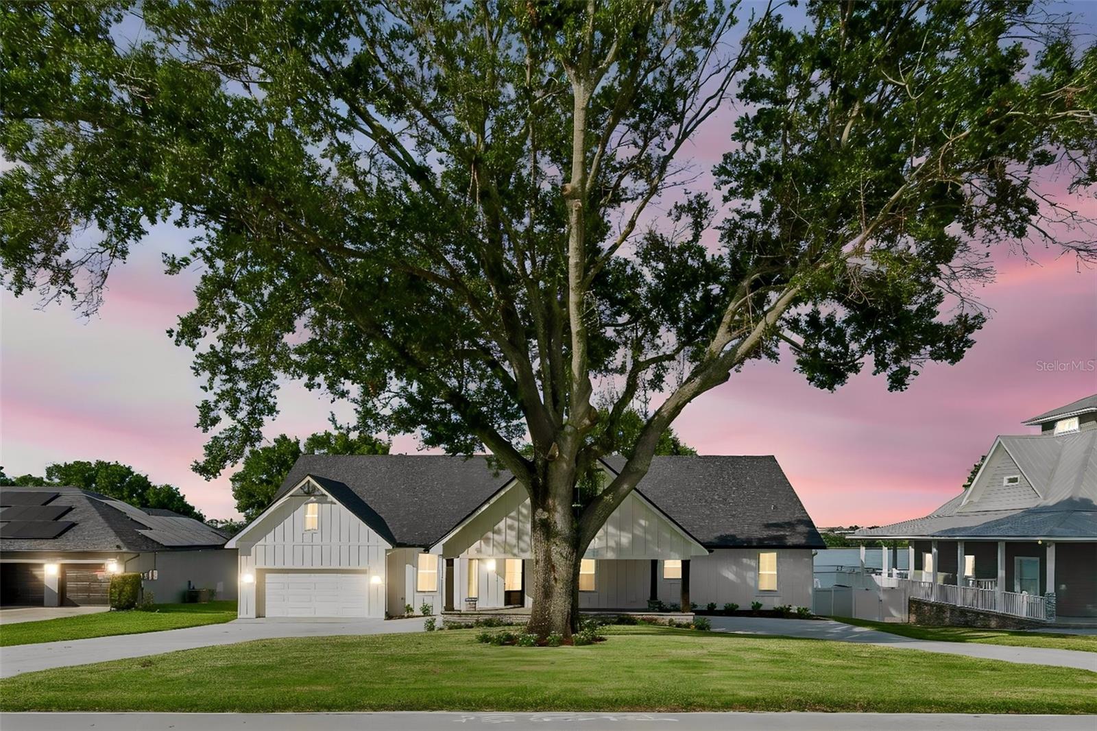 Welcome to your dream lakefront retreat! This beautifully finished custom home, professionally built by the multi-award-winning builder Ash Built Construction, offers the perfect blend of luxury, comfort, and waterfront living. Boasting five spacious bedrooms and five beautifully appointed bathrooms, this exceptional property is designed for both everyday living and effortless entertaining.
Inside, you’ll find stunning luxury vinyl plank flooring throughout the main living areas and elegant luxury tile finishes in every bathroom, creating a sophisticated yet durable living space. The kitchen features an 8 foot custom built island with stunning white and navy blue quartz countertops, with seating for 4 and a spacious walk-in pantry, offering both style and functionality. The thoughtfully designed floor plan provides generous living areas, abundant natural light, and high-quality craftsmanship at every turn.
The Master bedroom is a roomy retreat with stunning view of beautiful Lake Tennessee.  The master bath speaks for itself, with a spacious and luxurious shower tiled from floor to ceiling.The laundry room is equipped with a luxury laundry sink which doubles as a pet bath. Perfect for your most precious 4-legged friends! 
One of the home’s most unique features is the hidden bonus room above the garage, accessed through a discreet bookshelf-style entrance that blends seamlessly into the wall in the 4th bedroom upstairs. If offers the perfect space for a playroom, game room, media room, home office, or private retreat.
Step outside to enjoy 105 feet of pristine Florida lakefront. Relax on the covered back porch or expansive deck, both perfectly positioned to capture breathtaking water views and unforgettable sunrises. The back covered lanai is set up and ready for the new owner to build their dream outdoor kitchen, creating the ultimate space for outdoor dining and entertaining. Boating enthusiasts will appreciate the covered electric boat lift, making it easy to enjoy days on the water whenever the mood strikes.
Whether you’re looking for a full-time residence, a vacation getaway, or the ultimate place to entertain family and friends, this extraordinary lakefront home delivers exceptional craftsmanship, luxurious finishes, and the Florida waterfront lifestyle you’ve been dreaming of. Schedule your showing today!

Room measurements are approximate.  Some of the pictures are Virtually Staged.