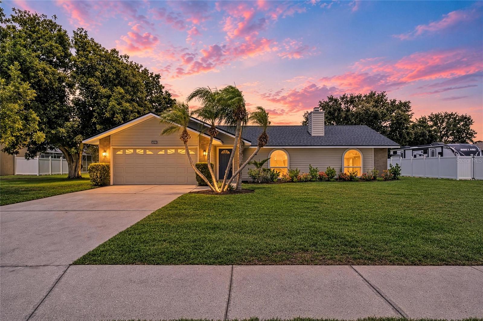Virtually Staged. Waterfront and golf course views in the heart of Braden Woods community. This 2,002 sqft, 3-bedroom, 2-bathroom pool and spa home offers the perfect blend of functionality and opportunity, nestled on over a half-acre lakefront lot in one of the area's most desirable neighborhoods in Bradenton. From the moment you arrive, you'll be impressed by the lush, mature landscaping, with new Citra Blue St. Augustine sod, new roof (2025), new exterior Hardie Board siding with fresh paint, and generous 2-car garage, offering plenty of parking and curb appeal. Step inside and discover a completely updated beautiful home with new luxury vinyl plank flooring and recessed lighting throughout, high vaulted ceilings, and a well-designed floorplan with a formal living room with a wood-burning fireplace at the front of the home, ideal for entertaining or creating a quiet retreat. Just beyond, the open-concept kitchen and family room provide a bright and airy space overlooking the pool, lake and golf course. The remodeled kitchen is outfitted with brand new quartz counters, solid wood soft-close drawers and cabinets, kitchen sink, Frigidaire stainless steel appliances, and a spacious breakfast bar for casual meals, morning coffee, or catching up with guests. The primary suite is a peaceful escape with a large walk-in closet, plus an updated spa-like en-suite bathroom featuring new vanity with quartz counters, dual sinks, a walk-in shower and a luxurious freestanding soaking acrylic bathtub. The bathroom also provides a private toilet room with an additional sink and access to the lanai and pool area. The split floor plan offers two additional bedrooms and a shared updated bathroom with quartz counters and dual sinks, perfect for guests and family. Out back, your Florida lifestyle awaits. Remodeled in 2025, the heated pool and spa are designed with a NPT Pebble texture, new pavers and pool cage with an amazing view of the lake and golf course directly behind the home. Relax under the enclosed lanai, take a dip in the sparkling pool, soak all your worries away in the spa with a glass of wine, and enjoy cookouts with family and friends. With over half an acre of land, you’ll enjoy the privacy and serenity of this oversized lot, something hard to come by. Some additional updates include new impact windows in the front living room and both guest bedrooms, ceiling fans, interior paint, irrigation system and exterior lighting. Braden Woods is admired for its low HOA fees, spacious lots, and minimal restrictions, all while being conveniently close to top-rated schools, shopping, dining, and only a few minutes to I-75. Best of all, you're just about 45 minutes from the sugary sandy beaches of Anna Maria Island, perfect for spontaneous beach days or weekend getaways. Don’t miss your chance to own a slice of paradise. Schedule your private tour today.
