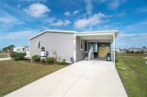 Don't miss this exceptional 2019 Palm Harbor home—offering the feel of new construction without the wait or hassle of building. This meticulously maintained 3-bedroom, 2-bath residence features an open-concept layout with a desirable split floor plan, soaring ceilings, crown molding, Bermuda shutters, ceiling fans throughout, and abundant natural light.

The gourmet kitchen is designed to impress with stainless steel appliances, including a range with built-in convection oven and air fryer, Bosch dishwasher, garbage disposal, a large center island with breakfast bar seating, and ample cabinetry for storage.

The spacious primary suite offers a walk-in closet and a private en-suite bath featuring dual vanities and an oversized walk-in shower. Two generously sized guest bedrooms provide comfortable accommodations for family and visitors.

Additional updates include a tankless hot water heater a newer roof (2023) and a new Air Conditioner (December 2025)

Located in the highly desirable Village of Holiday Lake, residents enjoy access to 20+ boat slips, a community boat ramp, two heated pools, a BBQ area, and an active clubhouse with a full kitchen, craft room, woodworking shop, laundry facilities, tennis, pickleball, shuffleboard, and a full calendar of social activities. Golf carts are welcome!

Outdoor enthusiasts will appreciate the convenient boating and fishing access, while golfers will enjoy several nearby courses. Beautiful Gulf beaches, waterfront dining, shopping, and local favorites such as Gerry's Tiki Hut, Farlow's on the Water, and SandBar Tiki & Grille are just minutes away.

Whether you're searching for a full-time residence or the perfect seasonal retreat, this home offers the ideal blend of comfort, convenience, and the best of Florida Gulf Coast living.