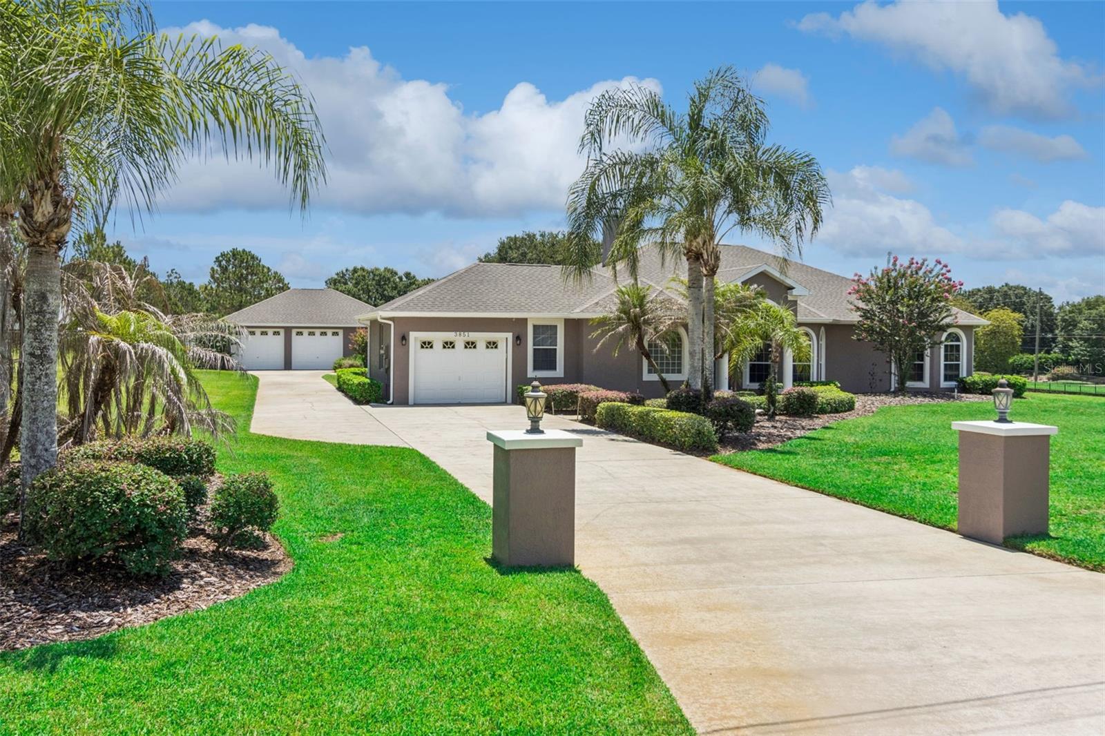 Exceptional custom-built pool home over half an acre with no HOA, a detached garage/workshop, 3 Br/ 2.5 baths and over 2,500 square feet of thoughtfully designed living space, offering the perfect blend of luxury, comfort, and functionality.

Designed for entertaining, the open floor plan features soaring cathedral ceilings, ceramic tile flooring throughout, a wood-burning fireplace, and two sets of triple sliding glass doors that seamlessly connect the living area to the expansive screened lanai and sparkling saltwater pool.

At the heart of the home is a gourmet kitchen that will impress even the most discerning chef. Complete with granite countertops, rich wood cabinetry, a center island, breakfast bar, gas cooktop, Thermador vent hood, built-in double ovens (one is convection), stainless steel appliances, wine cooler, and abundant workspace, it’s the perfect gathering place for family and friends. A spacious formal dining room, casual dining area, and well-equipped laundry room with cabinetry, utility sink, washer and dryer, and walk-in pantry provide both convenience and functionality.

The desirable split-bedroom floor plan offers privacy for everyone. Pocket doors create a private guest wing with two spacious bedrooms and a full bath. The luxurious primary suite serves as a peaceful retreat featuring French doors to the lanai, an elegant tray ceiling, dual walk-in closets, dual vanities, and an incredible spa-inspired walk-in shower with dual shower heads and an overhead rain shower.

Outdoor living is just as impressive. Relax beside the freeform saltwater pool surrounded by paver decking and an oversized screened enclosure featuring both covered and open-air spaces. Enjoy outdoor entertaining with a convenient half bath, outdoor shower, gas hookup for your grill (buried propane tank, owned), TV mount, and built-in speakers—everything needed for year-round Florida living.

Car enthusiasts, hobbyists, and boat owners will appreciate the oversized attached garage with overhead storage and additional refrigerator, plus the impressive 28’ x 36’ insulated detached garage/workshop complete with a bonus room ideal for a home office, fitness room, craft studio, or additional storage. Added peace of mind comes from a Generac half-home generator.

This is more than a home—it’s a lifestyle. Offering exceptional indoor and outdoor living, premium upgrades, abundant storage, and space for all your passions. Excellent Location between Lake Easy & Crooked Lake. 

Recent updates include: New roofs with solar fans 2025, exterior paint 2025, New pool Pentair Intellicor Chlorine generator 2026, Poly slip-resistant floor finish on lanai 2026, HVAC ductwork replaced and UV lighting added 2022