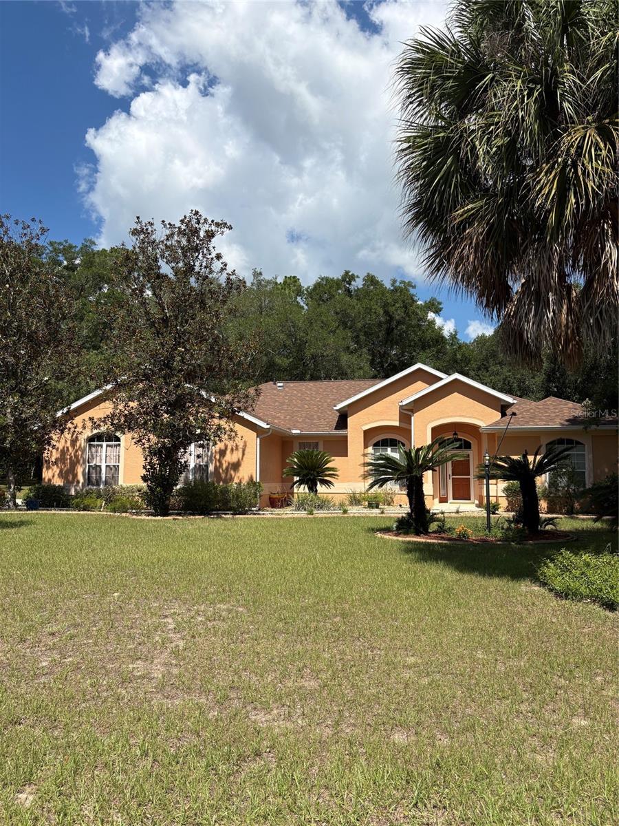 Rainbow Springs Country Club Home with oversized lot.  This home is ready for entertaining...private access to Rainbow River and more!  Living/ dining combo has sliding door to the lanai.  This space is also perfect if you work from home.  The kitchen is open to the family room with access to lanai.  The kitchen has plenty of counter space, cabinets and a closet pantry. Whirlpool appliances, Refrigerator June 2025.  Laundry room has storage cabinets and hanging rack to help on laundry day! it is inside and accessible from kitchen.  The two car garage has a built-in workspace area for crafts, work bench, storage etc.  This home has a split bedroom plan- the primary bedroom is accessed from the living room.  The room also features sliding doors to the lanai.  There are two walk-in closets with shelving. The primary ensuite bathroom is spacious!!  Separate vanities with cultured marble sinks, built-in medicine cabinets, with lots of storage cabinets, a garden soaking tub to relax after a long day on the river!!  A separate water closet and walk-in sunken shower with glass door. The guest bedrooms are spacious one with two built-in closets and the other with walk-in.  The guest bathroom has cultured marble sink with, storage cabinets, built-in medicine cabinet, linen closet and tub/shower combo.  The oversized lot .67 acres is spacious with mature trees, landscaping and plenty of space to add your own special touch. This home has a new roof 2024- HVAC- 2025 and Water Heater 2022.This home is located in the Rainbow Springs Country Club your ownership will provide you with private access to the Rainbow River Park.  You can enjoy a picnic, barbecue, go swimming at the private beach, tubing, canoeing and kayaking.  Community Center offers pickleball courts, pool, gym, billiards, private meeting areas, and organized activities for the residents.  Living in Dunnellon, Florida is quiet and peaceful just the perfect place to walk, bike ride and enjoy the beauty all around this river town.  The area has restaurants, shopping and hotels.  You can drive 20-miles to Ocala, 30 miles to Crystal River, 40 miles to Gainesville.  The WEC (World Equestrian Center) is 10 miles and hosts year round activities.
