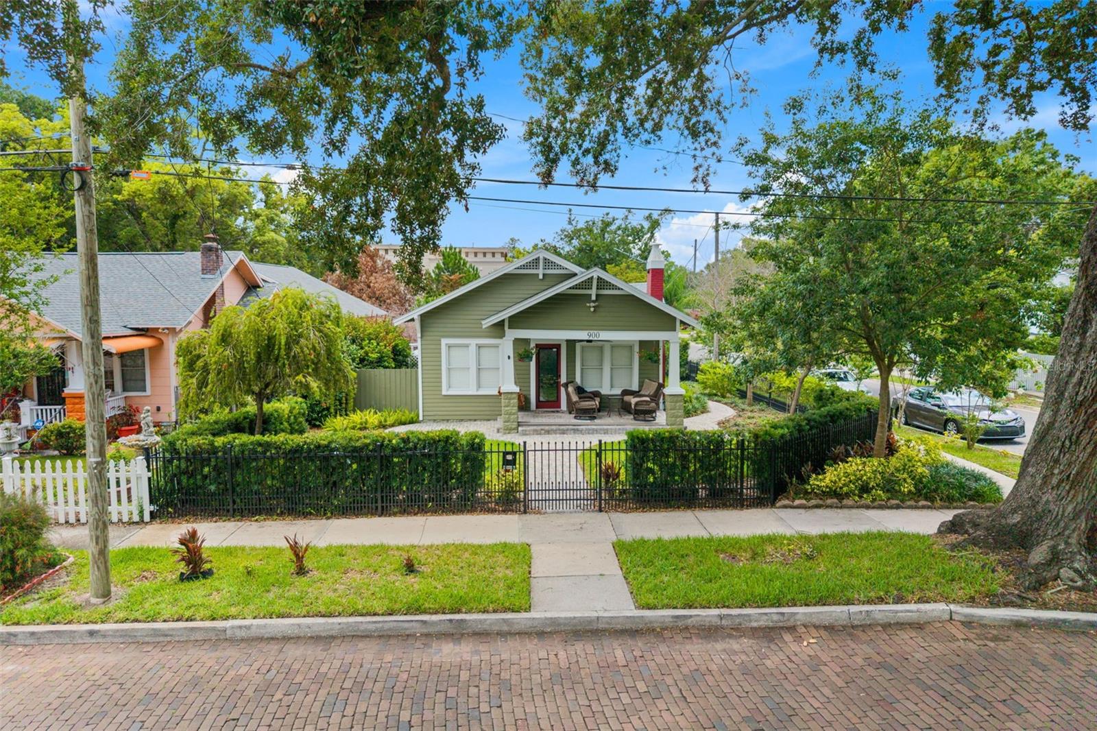 Nestled on a picturesque brick-paved street in the heart of Thornton Park, Pine Cottage is a beautifully preserved 1925 Craftsman cottage situated on a 7,807 sq ft corner lot, offering a rare combination of historic charm, updated infrastructure, exceptional walkability, and
future expansion potential. Filled with natural light, the home showcases rich hardwood and luxury vinyl plank flooring, elegant
crown molding, and energy-efficient windows throughout. Major infrastructure improvements provide peace of mind, including updated HVAC, electrical, and plumbing systems, an insta-heat tankless hot water system, and a new CertainTeed roof with warranty (11/2025). Additional enhancements include attic insulation, a 5-year termite bond, and a 12-foot-wide security gate. Outdoor living is equally inviting with a fully fenced yard, welcoming front porch, rear grilling and entertaining area, paver hardscaping, updated landscaping, a mature fruit tree, and a beautiful canopy of majestic oak trees providing privacy and shade. Just minutes from Lake Eola, Dickson Azalea Park, Langford Park, Thornton Park cafés and dining, farmers markets, and downtown Orlando's business, arts, and entertainment district, this location
offers one of Orlando's most desirable urban lifestyles. Approved ADU Plans Included A unique feature of this property is the inclusion of approved architectural designs for a 2-car garage with two accessory dwelling units (ADUs), which will be conveyed to the buyer at closing.
Whether envisioned for future income potential, guest accommodations, multigenerational living, or long-term investment value, these approved plans provide a rare opportunity while avoiding the time and expense of the initial design process. Buyer to verify permitting and construction requirements. Pine Cottage presents a unique opportunity to own a piece of Thornton Park history while enjoying the benefits of thoughtful updates, a prime corner-lot location, and future expansion possibilities.