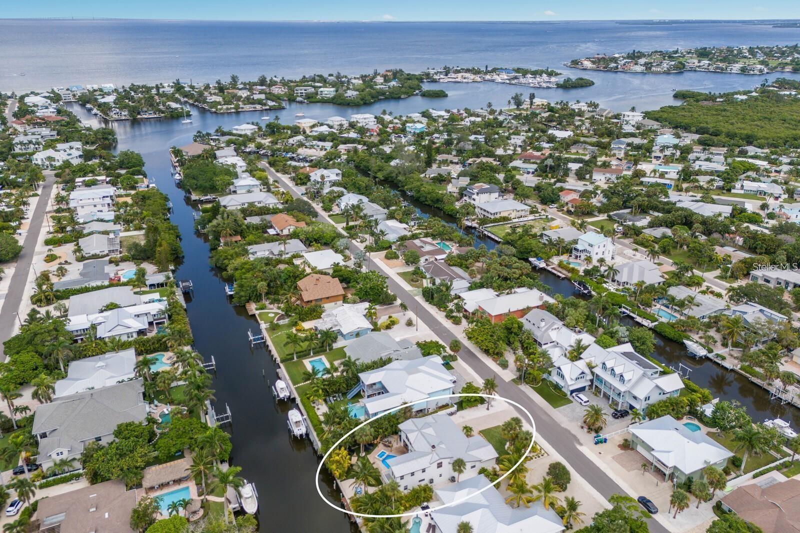 STUNNING RENOVATED 5 BEDROOM POOL HOME ON A DEEP WATER CANAL ONLY STEPS FROM THE BEACH!!! Nestled on the highly coveted north end of Anna Maria Island, this beautifully renovated and turnkey furnished 5-bedroom, 5-bathroom home spans 3,844 sq. ft. of luxurious living space. Perfectly situated on a deep-water canal with direct Gulf of Mexico access, this home is a dream for boating enthusiasts while also being just moments from the island’s pristine beaches. Upon entering, you’ll be greeted by a flood of natural light, creating a bright and airy atmosphere that welcomes you into this thoughtfully designed home. The living room offers ample seating and flows seamlessly into the adjacent dining room, where elegance meets functionality. With light flooring and coastal tones throughout, the home exudes a relaxed yet sophisticated vibe. The dining room opens easily to the kitchen and outdoor pool area, making it an ideal space for entertaining. The gourmet kitchen is a chef's delight, featuring quartz countertops, custom cabinetry, stainless steel appliances, and a cozy breakfast bar. From the living room, large sliding glass doors provide effortless access to the pool, creating a perfect blend of indoor and outdoor living. The first floor hosts three spacious bedrooms, each with excellent closet space, and three beautifully updated bathrooms, all exuding modern elegance. The expansive game room and laundry area combine fun and practicality, equipped with two washers and dryers, a second refrigerator, ample cabinetry, and a ping-pong table. Whether you’re hosting family or friends, this well-designed layout provides comfort for all. Upstairs you will find an additional two bedrooms and two bathrooms with an outdoor deck overlooking the canal. Renovated in 2023 and 2025, this home boasts an array of high-end upgrades including new appliances, new flooring, remodeled bathrooms, new lighting and fans, an outdoor kitchen, a new electric fireplace, freshly painted interiors and exteriors, new patio sliders, new putting green, a new front entrance door, and updated back doors.  Step outside into the breathtaking backyard, and you'll instantly be transported to your own private tropical retreat. The heated salt water pool and spa invite relaxation, while the outdoor kitchen, covered cabana with a dining area, tiki hut, and hammock offer multiple options for entertaining or unwinding. The putting green and dock complete this outdoor haven, where you can fish, relax, or simply enjoy the island lifestyle. Deep water canal with no bridges to the Bay, ICW and Gulf of Mexico. This home is an exceptional investment opportunity, benefiting from a transferable BERT HARRIS ACT RIGHT, ALLOWING SHORT-TERM RENTALS FOR UP TO 12 GUEST--a rare and valuable advantage. With a proven rental history, this property appeals equally to investors and those seeking a tranquil personal retreat. Every detail has been meticulously curated to create the perfect island home. Ideally located, this home is just a short stroll to the Anna Maria City Pier and the charming shops and restaurants along Pine Avenue. Whether you're looking for the ultimate vacation getaway or an income-generating property, this is truly a slice of paradise on Anna Maria Island.