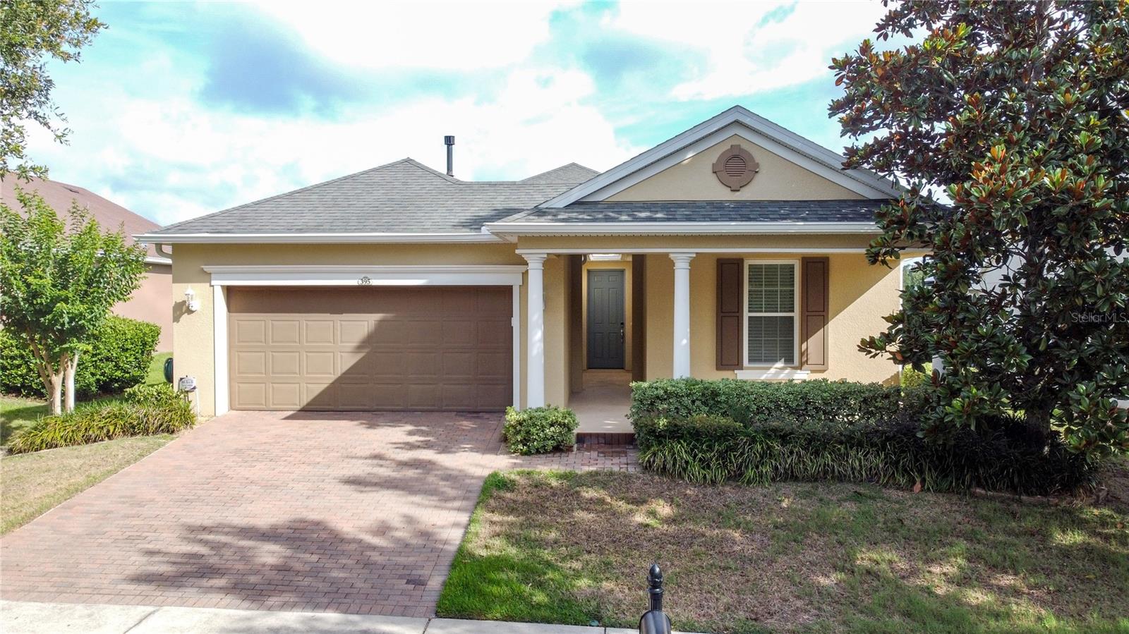 Nestled on a premium homesite with no rear neighbors and near a quiet cul-de-sac, this elegant and spacious open floor plan offers the perfect blend of privacy, style, and active living. The family room, dining room, and kitchen share a beautiful coffered ceiling, creating a true gathering space. The family room features a stained-glass look with stunning wall frames flanking a stone-accent wall, and electric fire place, adding warmth and architectural interest. The kitchen boasts of rich cabinetry, a long peninsula and granite countertops, a GE Café series smart dual-fuel gas/electric range and refrigerator with a built-in hot water dispenser (wi-fi ready) and a whole house water purification system—providing great-tasting water while reducing the need for bottled water. Just off the kitchen is the Smart Space, a complete with a built-in desk, bookshelf, cabinetry for storage, and an enclosed top load washer and gas or electric option for the smart steam-care dryer behind closet doors—keeping everything organized and out of sight. Design details include upgraded wood looking porcelain tile throughout the main living areas, with ceiling fans thoughtfully placed throughout the home for added comfort. The spacious primary suite is a true retreat, offering a 2' extended bedroom area ideal for a sitting or reading nook, large windows with natural light, peaceful backyard views, and plush carpeting. The luxurious en-suite bath features a stand alone shower, dual vanities, a double-flush toilet, and a generous walk-in closet. Guests will appreciate a well-appointed guest bedroom and full bathroom, plus a versatile den that can serve as a home office, hobby room, or additional guest space. Two convenient closets in the entryway provide extra storage and help keep the home clutter-free. Enjoy effortless indoor-outdoor living on the large screened-in lanai, complete with a natural gas line for grill cooking, TV connections, and ample room for dining and lounging. The TV and patio furniture convey, making this space ready for immediate enjoyment. Modern smart-home features include a WiFi-enabled smart thermostat and smart garage door opener, both controllable from virtually anywhere. Energy-efficient dual-pane Low-E windows and leased solar panels with payments PAID IN FULL through 2035 (transferable to the new owner) provide long-term energy savings. The garage offers upgraded electric service and built-in closets for exceptional storage and workspace flexibility. Curb appeal is enhanced by a distinctive exterior retention wall and paver driveway, creating a polished and inviting first impression, along with your own mailbox and a peaceful neighborhood feel. A 1 YEAR HOME WARRANTY IS OFFERED. Residence enjoy the spectacular 57,000 sq. ft. Magnolia Clubhouse with a private full-service restaurant/bar, an indoor/outdoor heated pool, a state-of-the-art athletic club with daily instructor-led classes, arts and crafts studio, card rooms, culinary kitchen, tennis, pickleball, bocce, golf simulator, and an event center with a full calendar of social events. Just 4 miles outside the gate, enjoy everyday conveniences such as a new Advent Health hospital, medical offices, dining & convenient access to the Florida Turnpike. If you are a traveler, cruiser or beach enthusiast, Port Canaveral is 90 minutes to the east, Florida beaches just 90 minutes to the west and east and a 40 minute drive to the Disney theme parks and the Orlando International Airport.