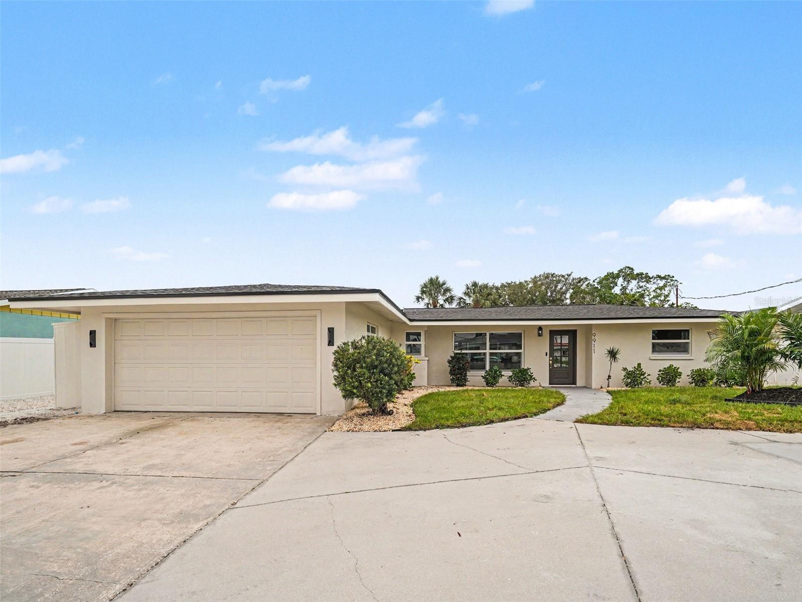 Welcome home to 9911 Royal Palm, where absolutely all the heavy lifting has already been done for you! The moment you pull up, you'll notice the crisp look of the fresh exterior paint and beautiful new windows, all topped off with a brand-new roof that guarantees ultimate peace of mind for years to come. Step inside, and the fresh interior paint perfectly sets the stage for a bright, modern living experience. If you love to cook or entertain, you are going to fall head over heels for the kitchen. It has been completely redesigned with stunning all-new cabinets, gorgeous quartz countertops, and a sleek suite of state-of-the-art appliances that will make every meal feel like a special occasion. When it is time to unwind, your primary ensuite serves as a true private retreat. It features a massive walk-in closet with plenty of room for your entire wardrobe, a luxurious soaker tub perfect for melting stress away, and a very large walk-in shower that feels like your own personal everyday spa. But let's be honest, you are probably going to want to spend most of your time out back! The outdoor living space is a total showstopper. Step out onto beautiful new patio pavers surrounding your freshly refinished pool, which runs flawlessly on brand-new equipment. For boating enthusiasts, the waterfront setup is an absolute dream. Stroll down to your private dock featuring gorgeous, low-maintenance new Trex decking. Getting out on the water has never been easier thanks to the brand-new boat lift motor, which includes a remote control for incredibly easy docking after a fun day on the water. 9911 Royal Palm isn't just a house; it is a completely updated, turnkey lifestyle just waiting for you to drop your bags and move right in. Come check it out!