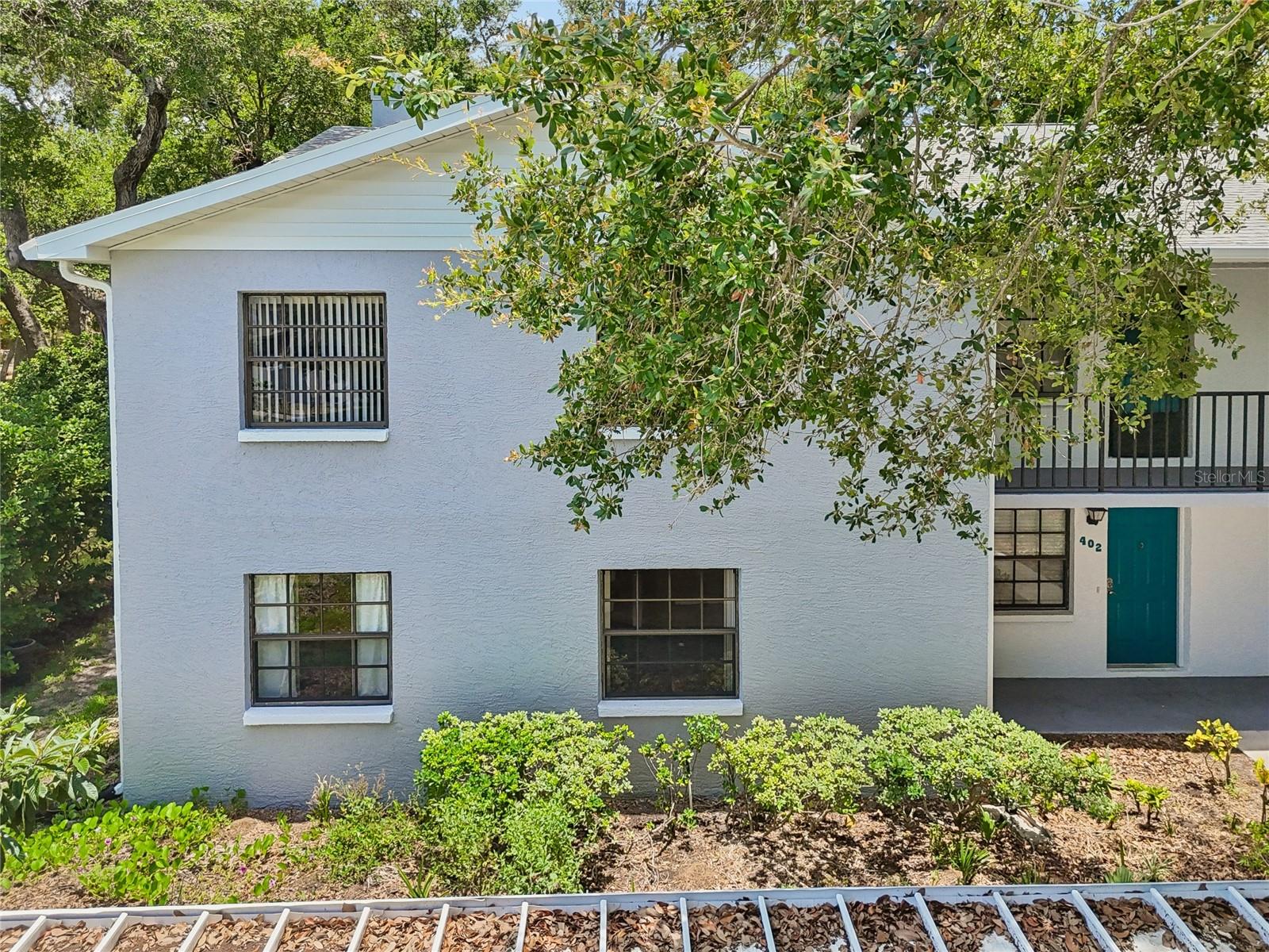 RARE GROUND-FLOOR END UNIT WITH DUAL PATIO RETREATS, COVERED PARKING IN PRIME SEMINOLE! Discover the perfect blend of privacy and convenience in the highly desirable end-unit condo at the Oaks of Seminole. It's situated on the ground floor for effortless, stair-free living. Offering 1,210 sq. ft. of comfortable living space, this home is move-in ready. Step inside to find a fresh, clean interior showcasing updated durable vinyl flooring throughout and crisp, recently painted walls that provide the perfect backdrop for any decor. The kitchen features ample workspaces, lots of cabinets and newer refrigerator and dishwasher. This unit even has the convenience of an in-unit washer and dryer. The primary bedroom features a step-in shower and large closet.  Step outside to choose your favorite relaxation spot: enjoy your morning coffee on the covered patio or retreat to the screened-in patio. With its ground-floor access and end-unit privacy and covered parking, this condo offers the feel of a single-family home. Conveniently located near shopping, dining, and beautiful beaches.