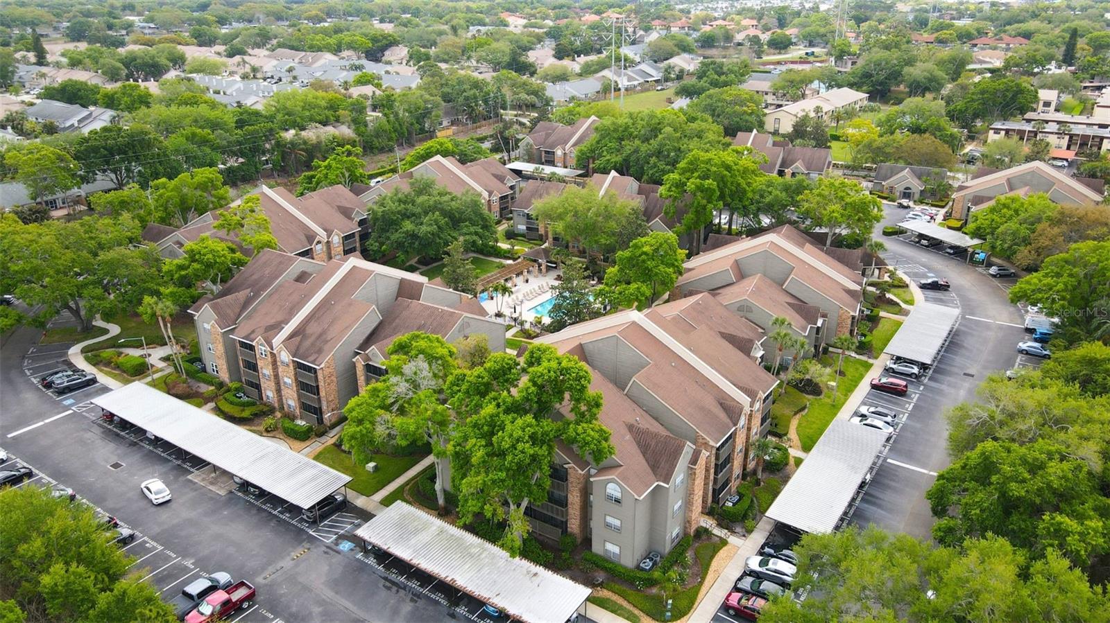Welcome to resort-style living in the highly desirable gated community of The Fountains at Countryside! This beautifully updated second-floor, 2-bedroom, 2-bath condominium offers a flexible floor plan that functions perfectly as two private primary suites. Sparkling clean, move-in ready and meticulously maintained, this home features an updated kitchen with new cabinetry, stone countertops, and newer appliances, along with luxury flooring throughout, fresh interior paint, updated bathrooms, and modern LED lighting with remote controls in the living and dining areas. The spacious living room is enhanced by a custom-built entertainment center with a remote-controlled electric fireplace, and the mounted TV is included with the sale. A new hurricane-impact sliding glass door opens to the screened lanai, creating the perfect space to relax and enjoy Florida's year-round sunshine. Additional improvements include hurricane-impact windows and sliding door installed in 2020 with custom plantation shutters throughout. HVAC system, water heater, dishwasher, and garbage disposal installed in 2020. Both bathrooms have been tastefully updated with new vanities, sinks, and toilets, and the home includes a convenient indoor laundry closet, complete with washer/dryer. Assigned parking is located directly in front of the unit for added convenience. Residents enjoy a truly maintenance-free lifestyle with exceptional amenities, including a heated swimming pool, outdoor spa, fitness center, workout studio, elegant clubhouse, dog park, butterfly garden, grilling stations, and scenic walking paths. The comprehensive HOA fee covers cable TV, water, sewer, trash, exterior maintenance, grounds maintenance, pest control, pool maintenance, security, insurance, and professional management, providing outstanding value and peace of mind. Located in a non-flood zone and non-evacuation zone, this property offers added security and confidence. Conveniently situated near world-famous Gulf beaches, premier shopping, dining, entertainment, and major transportation routes, this home combines tranquility with accessibility. Whether you're seeking a primary residence, seasonal getaway, or low-maintenance Florida lifestyle, this turnkey condo delivers it all. Schedule your private showing today and discover why every day feels like a vacation at The Fountains at Countryside!