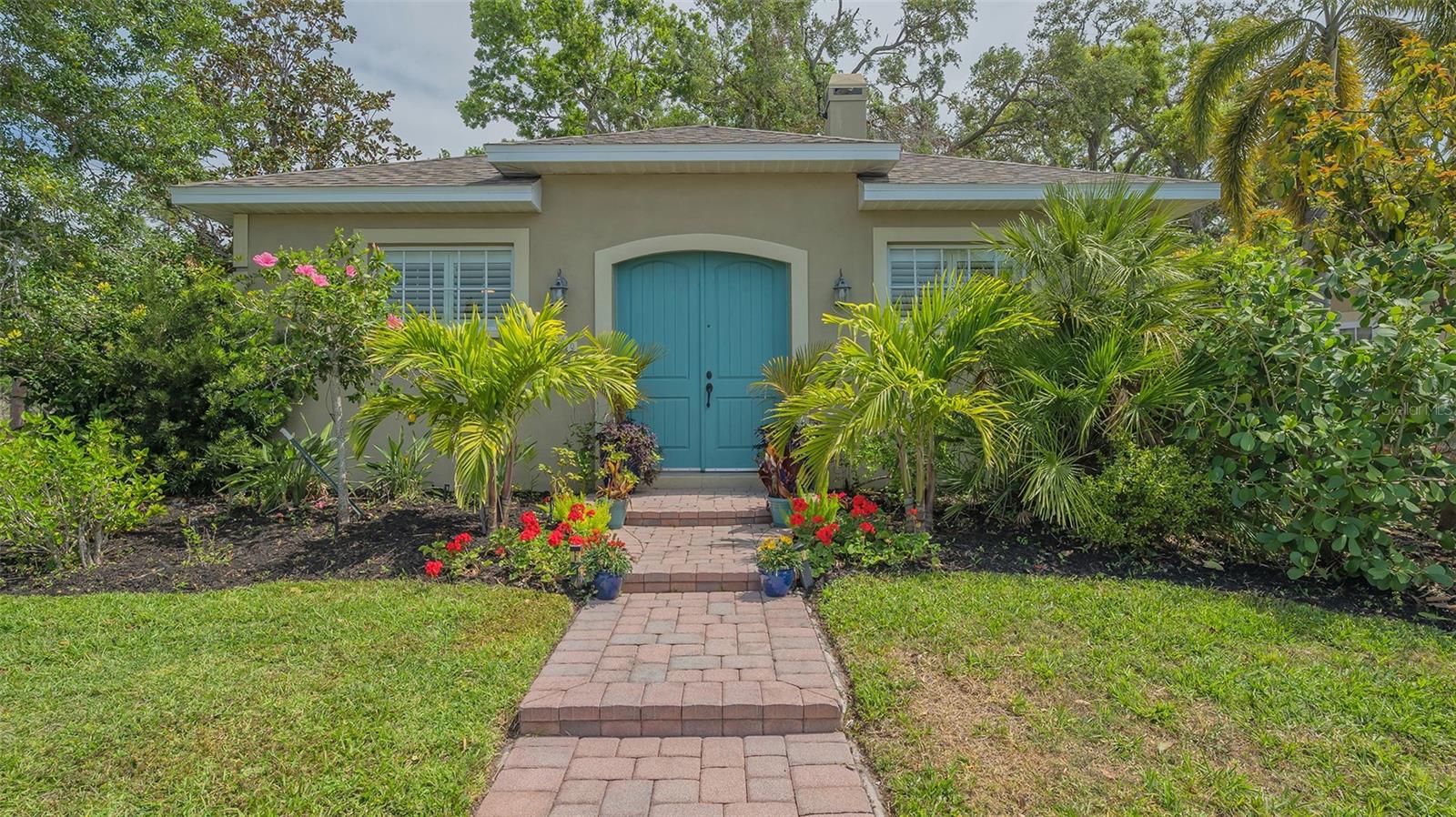 Welcome to this unique custom offering of blended versatility, which includes 3 bedrooms with 3 baths. A concrete block custom build in 2005. Directly across the road from Gillespie Park, a dazzling 10-acre monitored park. Ideal for extended family, visitors, artist studio, and/or additional rental income, so just let your imagination run wild. High-impact hurricane windows and a newly installed roof in 2024 with hurricane tie-downs. The freshly painted main house features a double sided gas fireplace, stained acid-washed floors, a common feature throughout the compound, newly installed granite-honed countertops, new subway tiles in the kitchen and freshly painted solid wood cabinets. If it is purity you want, try the Apec Reverse Osmosis dispenser at the newly installed kitchen sink. Bosch gas cooktop, dishwasher and convection wall oven, Whirlpool refrigerator with Electrolux washer and dryer. Tankless on-demand hot water, gas for the main house, and an additional electric unit for the guest suites. A well for irrigation, EV 220-volt 50-amp charging station, storage bins and racks for kayaks, two driveways, private hedging with magnolia, holly, black bamboo and hibiscus, or if it's the fruit you want, mango, avocado, lemon, papaya and banana trees. An outdoor shower, brick pavers throughout the inspiring courtyard with hanging lights, and a fire pit to capture those spectacular starry evenings. One guest suite was built with the original house with a kitchenette, while the second was built in 2022, complete with a full kitchen and washer/dryer combo. Both suites come complete with mini-split heat pumps, one installed in 2023, and are turnkey furnished. Gillespie Park, which is directly across the street, features grand oaks, recreational trails, a lake, tennis courts, a pickleball court, a gazebo, a dog park and a basketball court. Centrally located and within short distance of Sprouts, Whole Foods, restaurants and local shopping, this neighborhood offers a vibrant and ever-evolving downtown neighborhood.