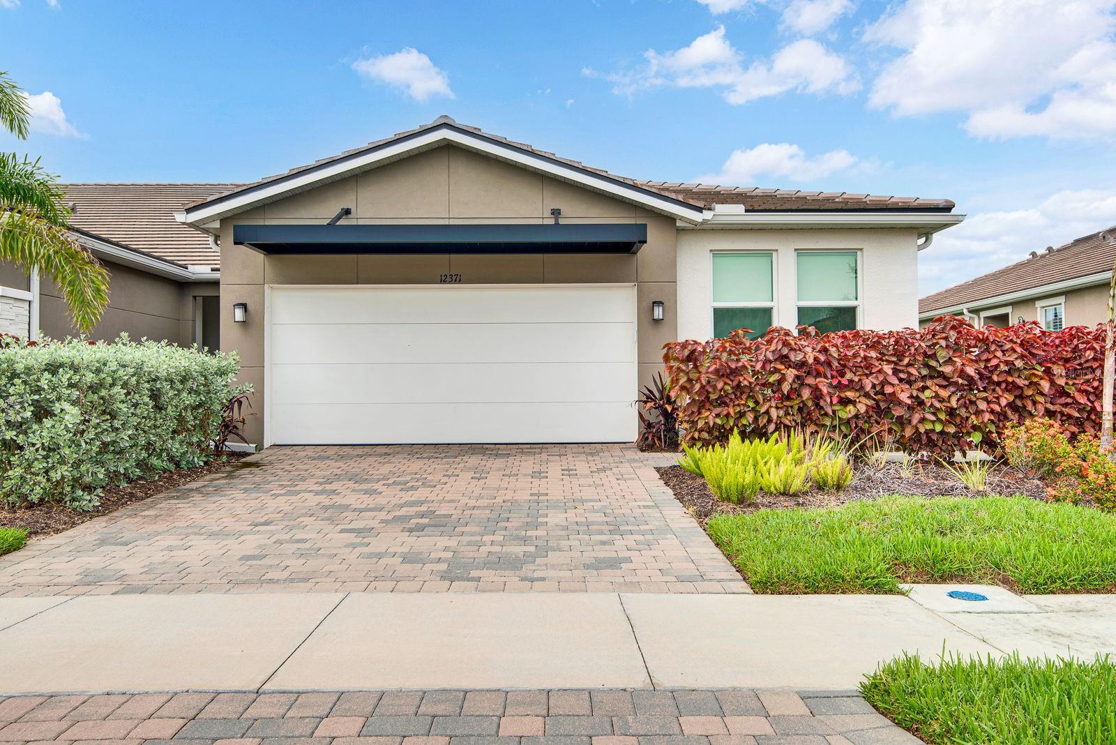 Move-in ready and loaded with upgrades in Sunstone at Wellen Park! This beautifully maintained 2024-built end-unit villa offers 3 bedrooms, 2 bathrooms, a versatile flex room, and an open-concept layout designed for effortless Florida living. Unlike new construction nearby, this villa comes with thousands in premium upgrades already done for you — hurricane impact windows, a whole-house water softener, a reverse osmosis water filtration system, and an upgraded extended lanai protected by accordion hurricane shutters for year-round peace of mind.
Inside, natural light fills the seamlessly connected living, dining, and kitchen areas. The kitchen features quartz countertops, shaker-style cabinetry, a breakfast bar, and abundant storage, while sliding glass doors extend your living space to the covered lanai. The private primary suite includes a spacious walk-in closet and en-suite bath with glass-enclosed shower, and the secondary bedrooms are thoughtfully positioned for privacy. The flex room makes a perfect home office, den, or hobby space.
All of this in Sunstone, one of Wellen Park’s most sought-after communities, with resort-style amenities and just minutes from Downtown Wellen Park, shopping, dining, golf, Gulf beaches, and CoolToday Park, home of Atlanta Braves Spring Training. Furniture is negotiable and may be available for purchase. Storm-ready, upgrade-rich, and truly move-in ready — schedule your private showing today!
