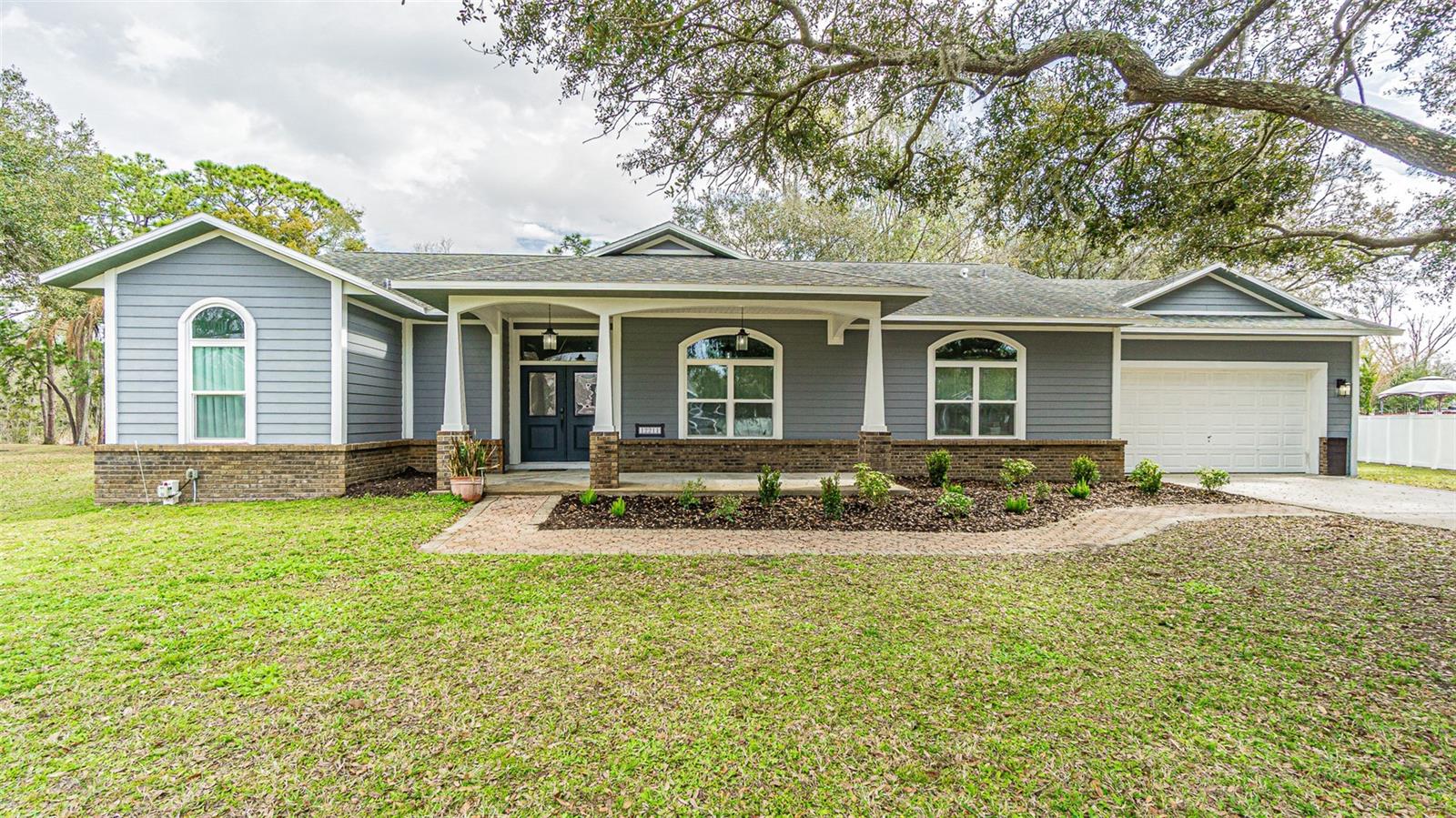 These unique custom homes rarely come available. Completely renovated and move-in ready, this stunning 3-bedroom, 2-bath heated pool home sits on nearly half an acre with peaceful conservation views in a quiet cul-de-sac setting with NO HOA.
Located just minutes from USF, Hwy 301, shopping, dining, and major commuter routes, this property offers the perfect combination of privacy, convenience, and upgraded luxury living. Surrounded by mature oak trees in a semi-secluded neighborhood, the home delivers the space and freedom many buyers are searching for but rarely find.
A large covered front porch and impressive double-door entry welcome you into an open-concept layout featuring soaring ceilings, beautiful tile flooring throughout, oversized living spaces, and a wood-burning fireplace that anchors the expansive great room. Natural light pours into the home through upgraded vinyl windows and multiple French doors leading to the screened lanai and pool area.
The fully remodeled gourmet kitchen is designed for entertaining and everyday living, showcasing custom glazed cabinetry with crown molding, extensive soft-close drawers, granite countertops, marble backsplash, under-cabinet lighting, stainless steel appliances, dual-temperature oven, convection microwave, wine refrigerator, coffee/server bar, and an oversized 4’ x 8’ granite island with seating and abundant prep space. A large pantry and additional breakfast nook cabinetry provide exceptional storage rarely found in homes of this size.
The spacious primary suite features French doors to the lanai, oversized walk-in his-and-her closets, and a beautifully updated bath with granite counters, upgraded cabinetry, and designer finishes. The guest bedrooms are generously sized, and the pool-access guest bath has also been tastefully remodeled.
Step outside to your private screened lanai and heated pool overlooking tranquil conservation views — an ideal setting for entertaining, relaxing, or enjoying Florida outdoor living year-round.
Additional upgrades and features include:
Extra-wide and extra-deep 2-car garage (approximately 29’ deep x 21’ wide)
11’ garage ceiling with epoxy flooring
Rear garage access door
Generator wiring
Water treatment system with softener, ionizer, and pH filtration
Hardie Board siding
Attic exhaust fan for energy efficiency
Full-house alarm system
Interior laundry room with utility sink and storage
Exceptional storage throughout the home
This custom-built property offers oversized rooms, high-end finishes, extensive upgrades, and the privacy of a large no-HOA homesite — all while remaining close to Tampa conveniences. Homes with this level of renovation, lot size, pool setting, and freedom from HOA restrictions are increasingly difficult to find.
Schedule your private showing today.