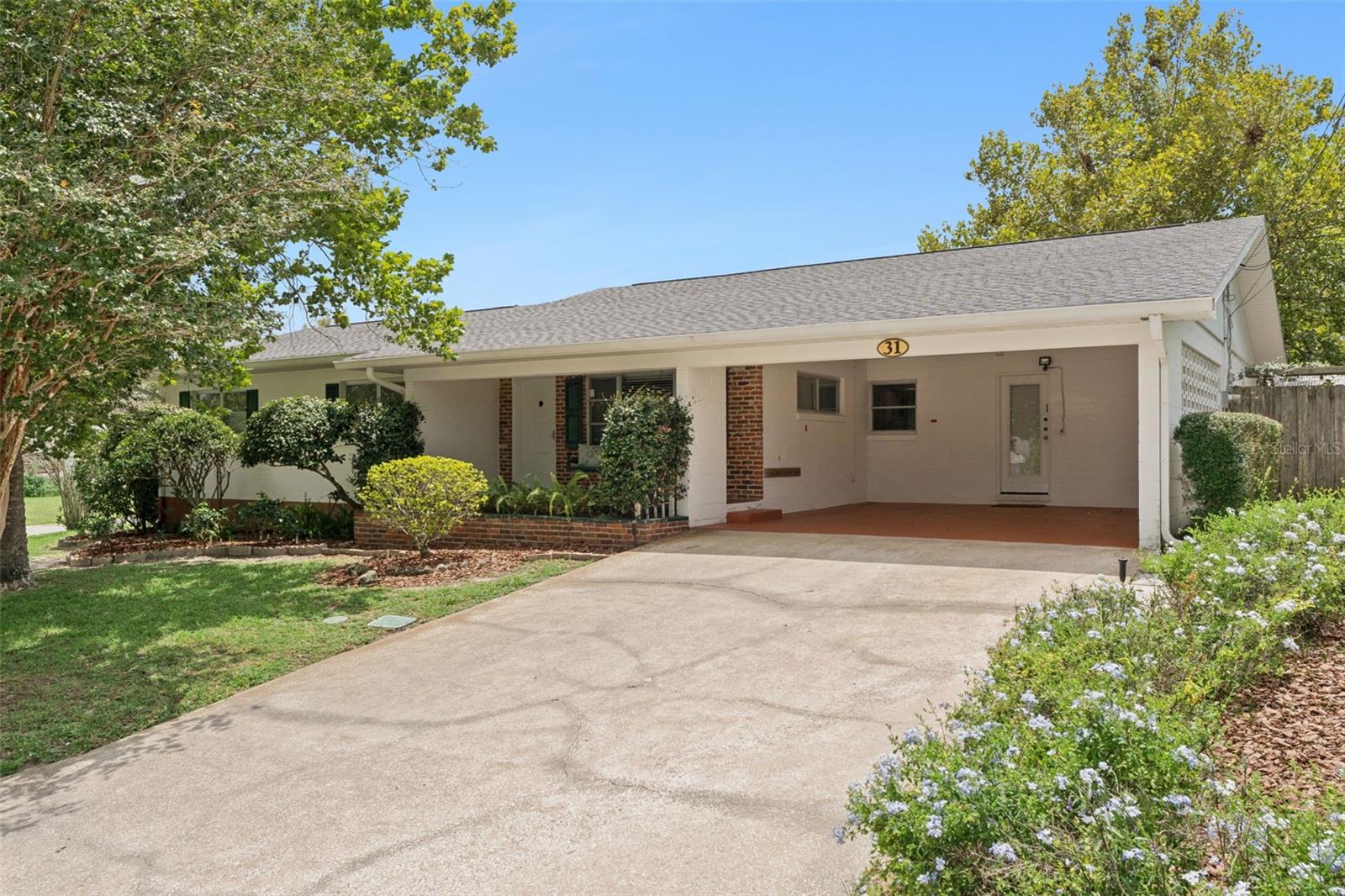 Welcome to 31 Jasmine Drive, a charming 3-bedroom, 2.5-bath home situated on a desirable oversized corner lot in the heart of DeBary. Featuring a 2023 roof, this inviting property offers peaceful water views that can be enjoyed while relaxing on the front porch swing. Inside, fresh interior paint and warm wood-look flooring create a bright, welcoming atmosphere. The spacious, flexible layout offers multiple living areas, including additional space that could serve as a Florida room, home office, hobby area, or second sitting room.

The updated kitchen features ample cabinetry, generous counter space, a tile backsplash, and a convenient pass-through, while the updated bathrooms add comfort and style. An interior utility room with a half bath provides added convenience and functionality.

Outside, the spacious yard is shaded by mature trees and complemented by established landscaping, a covered carport, and plenty of room to enjoy Florida living. Two detached workshops, both equipped with electricity, provide excellent storage and workspace. The larger workshop is perfect for a hobbyist, woodworker, or anyone needing space for projects, while the smaller workshop offers additional flexibility. Close to I4, Orlando, New Smyrna Beach and the new and up coming Debary Mainstreet.