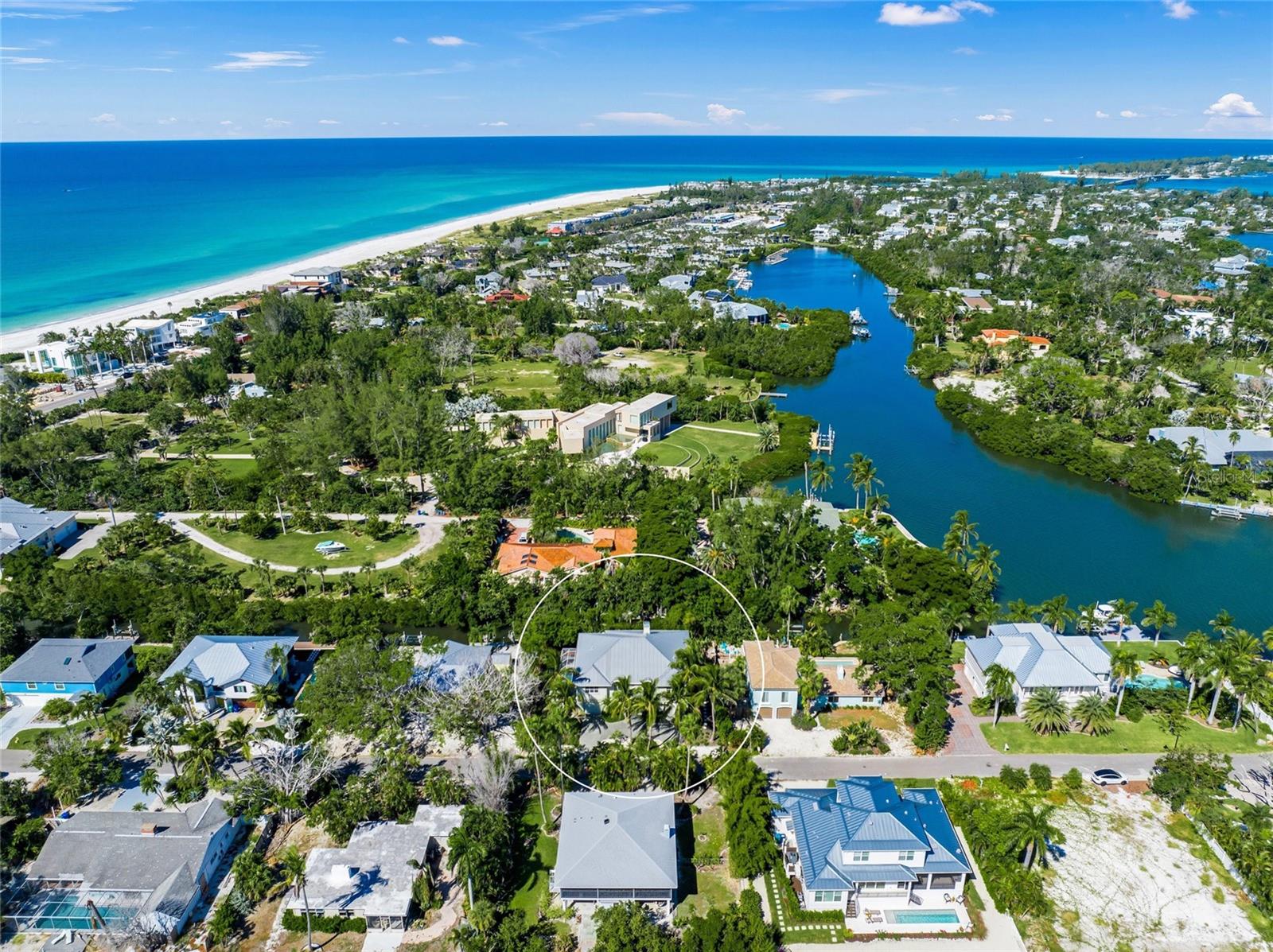 $100,000 PRICE REDUCTION!!! Live the ultimate Florida Waterfront lifestyle in this private, calm, secure, spacious and elegant large elevated coastal home.  Located on the North end of Longboat Key less than a mile to Anna Maria Island in the relaxed Sleepy Lagoon neighborhood with deeded beach access just around the corner, leading you to never crowded stretches of  sand.  The home is located on a boating canal just three houses in from the bay offering direct access to Sarasota Bay and the Intercoastal Waterway.  This large ( 5328 SF total) very well maintained and upgraded elevated home offers 2800 SF on the main living level plus 2500 SF of bonus space on the first floor with an elevator. This elevated, well-built custom home sustained no damage nor have any flood claims ever been filed.   This home spans two level of living and has an open floor plan, blending indoor and outdoor living.  The main living area is upstairs with large flowing open rooms, vaulted ceilings, a fireplace  and  features French Doors leading to a screened Lanai overlooking the natural canal with foliage for privacy.   The bedrooms are arranged in a split plan with each having en-suite bathrooms with lots of closets and built-ins.  The large eat-in kitchen has custom cabinetry with crown molding, pull-outs, granite countertops and stainless appliances plus a large separate dining room perfect for all your family or friends.  Just off the kitchen on the main living level is a very large laundry room along with all the closets in this home you will have all the storage you need. On the first level is the open foyer leading up to the living area with the elevator access and oversized split garages.  There is an additional 2500 SF of AC/heated of interior space that is finished with polished concrete floors and walls of sliding doors leading to the pool area, porch, deck, yard and dock area. Also just outside your bonus space is private 60’ long screened, heated lap pool with a full bath.  The property would provide great renal income also for a part time owner as it has in the past.  Walk the beach, swim in the pool or ocean, ride your bike on the Longboat Key Bike path,  fish, boat, kayak, paddle board, jet ski and enjoy your spacious home that is just a short drive to Sarasota, St. Armand’s circle and Anna Maria Island.  Please see the videos.  What are you waiting for?  Start living the dream.