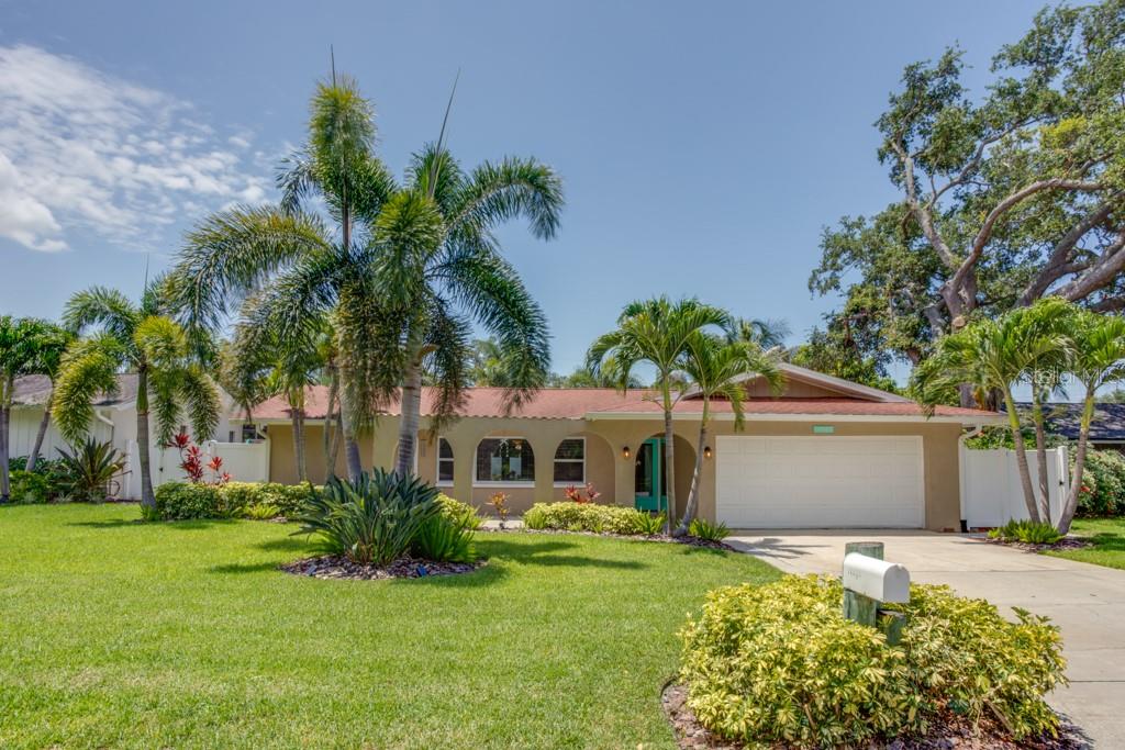 Coastal Living Without the Coastal Insurance — Move-In Ready Pool Home. Welcome to this beautifully maintained 3-bedroom, 2-bath pool home that delivers the best of Florida living without the headaches. Tucked just minutes from the beach yet sitting safely outside the flood zone, this home offers everything you love about coastal life with the bonus of significantly lower insurance costs. Step inside to a spacious family room where oversized sliders open directly to your private backyard oasis. The recently refinished pool features a built-in sun shelf — the perfect spot for little ones and pets to splash and cool off. The fully white vinyl fenced backyard is built for easy living, with a covered lanai for shaded entertaining and low-maintenance artificial turf that stays green year-round with none of the upkeep. The split floor plan places the master suite privately on its own side of the home, complete with a remodeled en-suite bath featuring dual sinks and a shower with classic subway tile, a built-in seating area, and frameless glass doors. On the opposite side of the home, you'll find two additional bedrooms and a second full bathroom — an ideal setup for family, guests, children, or a home office. Everyday living is a breeze here, too. The oversized indoor laundry room is air-conditioned and equipped with a utility sink and plenty of space for added cabinetry. Add in newer windows, newer A/C and insulation, and a 2-car garage, and you have a true turnkey home. Properties in Seminole that combine beach proximity, a resort-style pool, and low insurance costs don't last long.