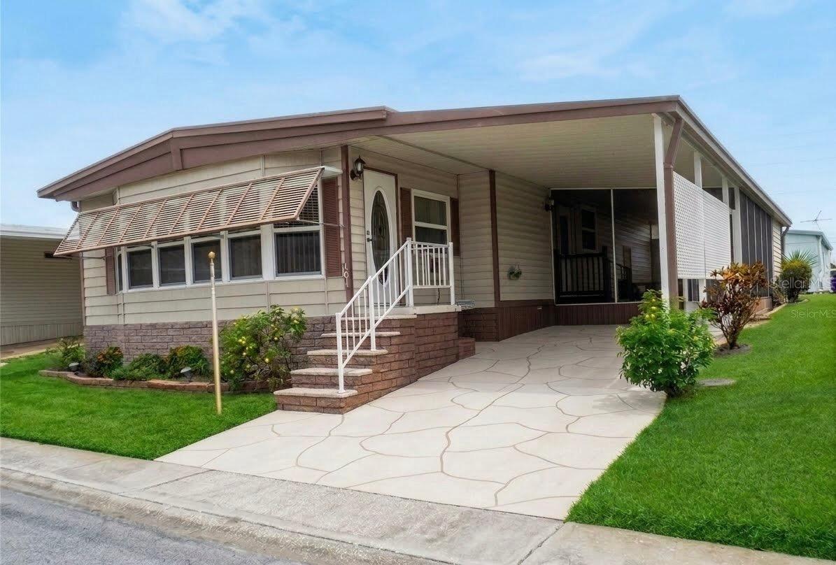 2 bedroom 2 bath with great curb appeal in no flood (X) area. Super looking remodeled baths and solid surface kitchen counters. Master bedroom has luxury vinyl floor and both bedrooms have walk-in closets.  The home has newer windows.  It also has a tankless water heater about 6 years old. It has a huge family room across the front lined all the way across with windows.  There are hurricane shutters for storm protection.  This is a 55+ community and this home alllows a cat, but, sorry no dogs.  This lovely home has a deeded lot 50X75 included in the price.  The low maintenance fee of $230/ Month includes water, sewer, trash, lawn, clubhouse, heated pool, a small lake behind the clubhouse, shuffleboard, Bocce ball, many more activities, private roads, and a lot where you can park your RV or your boat. Room measurements approximate.
