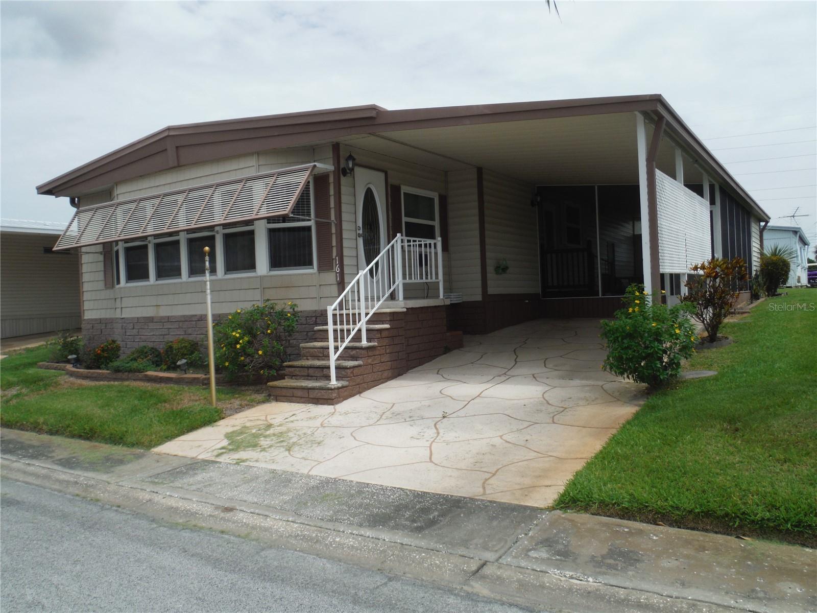 2 bedroom 2 bath with great curb appeal in no flood (X) area. Super looking remodeled baths and solid surface kitchen counters. Master bedroom has luxury vinyl floor and both bedrooms have walk-in closets.  The home has newer windows.  It also has a tankless water heater about 6 years old. It has a huge family room across the front lined all the way across with windows.  There are hurricane shutters for storm protection.  This is a 55+ community and this home alllows a cat, but, sorry no dogs.  This lovely home has a deeded lot 50X75 included in the price.  The low maintenance fee of $230/ Month includes water, sewer, trash, lawn, clubhouse, heated pool, a small lake behind the clubhouse, shuffleboard, Bocce ball, many more activities, private roads, and a lot where you can park your RV or your boat. Room measurements approximate.