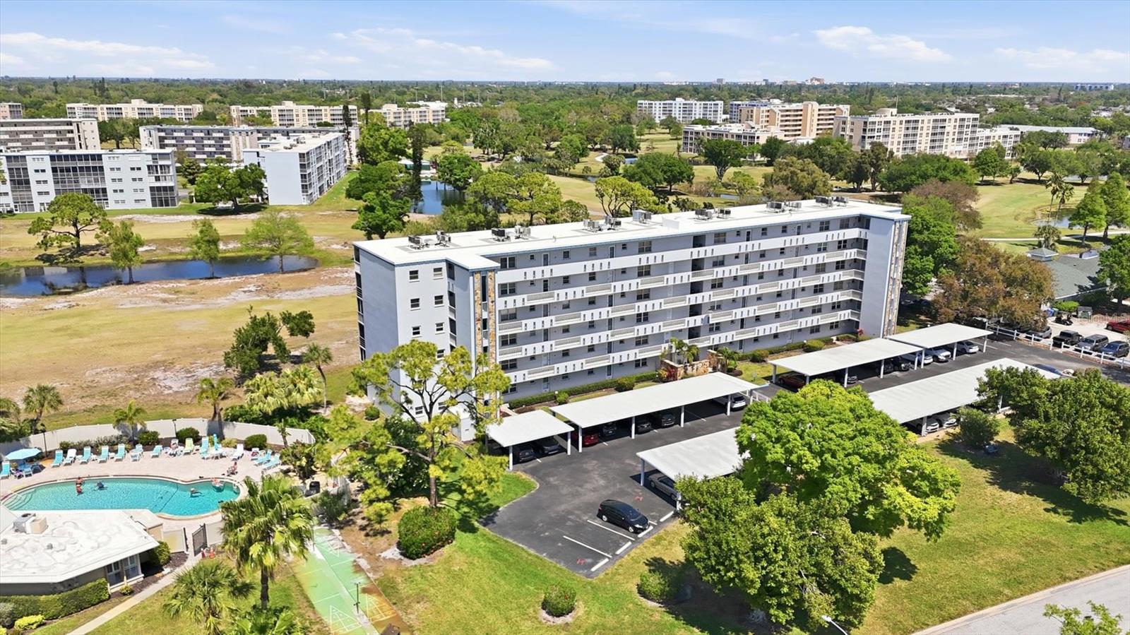 Welcome to Ironwood, located only 6.2 miles from the Gulf beaches of Anna Maria Island. This 2-bedroom, 2-bath 4th-floor corner end unit offers relaxing golf course views overlooking the #1 fairway and #2 green of the Pinebrook Ironwood Golf Community. Best of all, there are no additional golf course fees—enjoy the flexibility of a convenient pay-as-you-play course. This is an exceptional building location nestled between the Golf Pro shop to the east and the Rec I Clubhouse to the west. Enjoy peaceful panoramic views from the 6x15 glassed and screened lanai, perfectly positioned to take in the golf course and nearby pro shop. The open floor plan flows seamlessly from the foyer into the living room and out to the lanai, creating a bright and inviting living space. This furnished end unit is competitively priced and ready for its next owner. The kitchen features granite countertops, stainless steel appliances, parquet wood flooring, and a recently purchased Whirlpool refrigerator with front dispenser. Parquet flooring continues into the foyer, while the living room and both bedrooms have newer carpet. The spacious primary bedroom easily accommodates a king-size bed, offers private lanai access, and includes both a large walk-in closet and an additional closet for ample storage. Both bathrooms feature updated vanities, lighting, and fixtures. The guest bedroom has two single beds and a built-in closet.  The A/C replaced: 3/20/2022 and the Hot water heater replaced: 6/26/2018. Additional conveniences include carport #11, a private storage locker located next to the elevator, and a laundry room just steps away on the same floor. Residents enjoy easy access to the nearby Rec I Clubhouse, which offers a heated pool, fitness room, billiards room, grilling area, shuffleboard, banquet space, and tennis court access. Ironwood is a highly active community ideally located near everything you need, including 15 minute walk to the newly renovated G.T. Bray Park, a short drive to Robinson Preserve, Sarasota-Bradenton International Airport, and the stunning Gulf beaches of Anna Maria Island. This 55+ building does not allow pets, and new owners must hold ownership for two years before leasing. The monthly condo fee includes: Cable TV, Common Area Taxes, Community Pool, Escrow Reserves Fund, Fidelity Bond, Building Insurance, Internet, Maintenance Exterior, Maintenance Grounds, Maintenance Repairs, Manager, Pest Control, Pool Maintenance, Recreational Facilities, Sewer, Trash and Water.