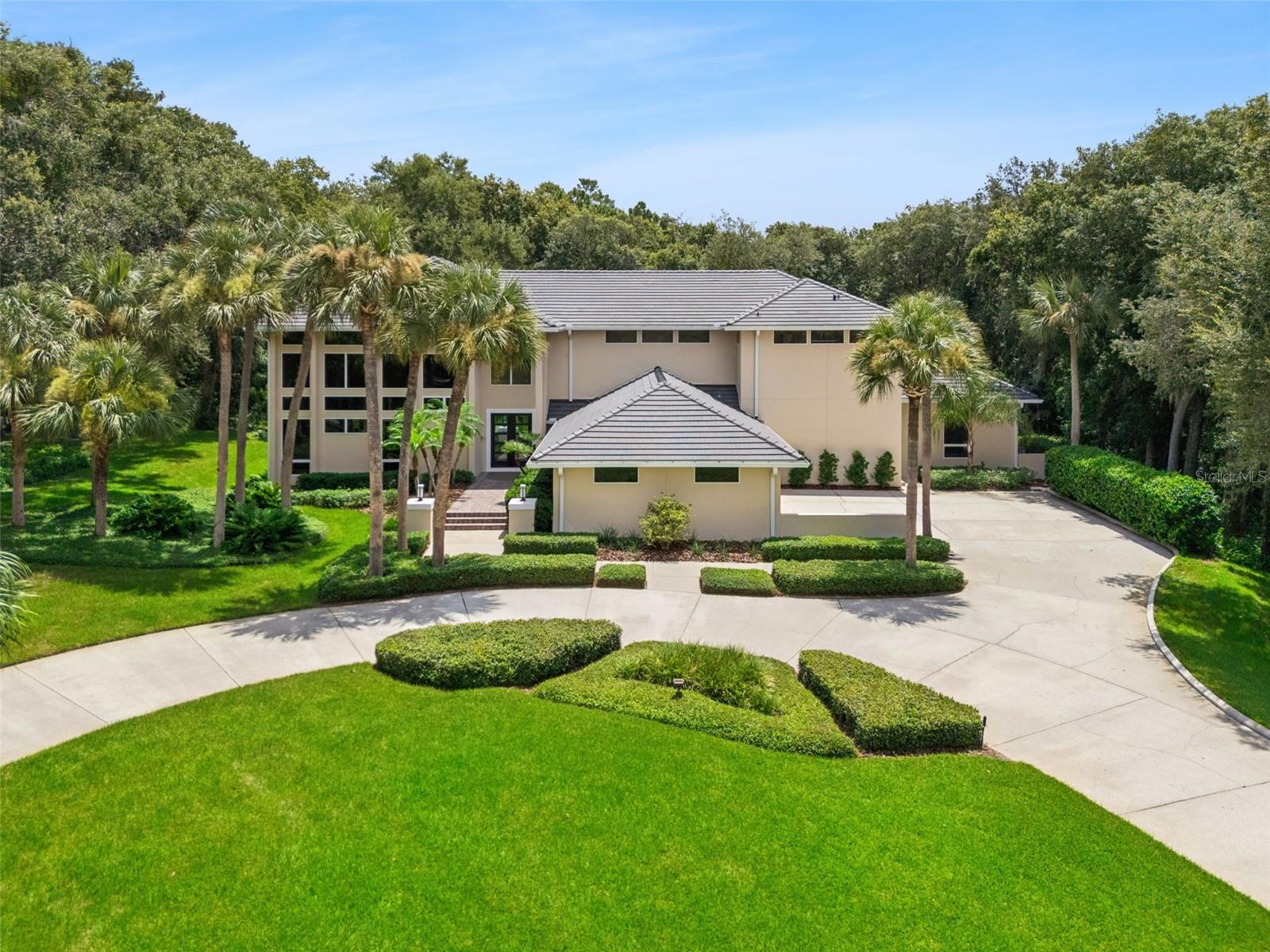 Virtually Staged. Stunning Contemporary Estate Home in Guard Gated Sweetwater Club situated on 1.25 acres of lushly landscaped grounds! Welcome to this spectacular home featuring 4 Bedrooms, 3.5 Baths with tropical pool and spa, its a two story architectural masterpiece with 5636 square feet of living area, Circular Driveway and oversized 3 Car Garage! Nature greets from you from every room with soaring ceilings and expansive windows throughout. METICULOUSLY MAINTAINED and move in ready for new owners. RECENT IMPROVEMENTS include NEW EAGLE TILE Roof 2025, Complete Re-pipe of House 2024, Re-Sod of Front and Back Yards 2025, NEW PROVIA Double Front Doors 2022, Two NEW 5 Ton CARRIER A/C Heat PUMP Systems 2025, Two NEW 50 Gallon Water Heaters 2024, NEW Garage Door Openers (3) 2026, NEW 3M UV Tinting of All First Floor Windows 2025, and more. As you enter the welcoming Foyer you'll see the tropical views of treed back yard and fabulous Dining Room Chandelier. To your left will be the voluminous Living Room with breathtaking views from the expansive windows and soaring ceilings featuring two main seating areas. The Dining Room features a UNIQUE Maitland Smith Chandelier and exquisite burlwood maple table and chairs for 10 guests, the windows invite nature's beauty to the table.  There is a Powder Room Bathroom off Entry for your guests. Onto the Gourmet Kitchen with separate Eat- In Nook Area, Double Islands for Gracious Entertaining, Many New Appliances and Solid Wood Cabinets and Granite Counters. You'll enjoy JennAir Double Ovens for holiday celebrations and a Sub-Zero Refrigerator,  NEW CAFE Cooktop with downdraft Vent, NEW Kitchen Sink, NEW GROHE Faucet, NEW InSinkErator Garbage Disposal, NEW GE Trash Compactor,  NEW BOSCH Dishwasher,  NEW GE PROFILE Microwave Oven and there is a HUGE WALK IN PANTRY! Adjacent Family Room is ideal for entertaining or relaxing with views of the sparkling Pool and Spa. There is also an outdoor Kitchen for Pool Parties! The 4th Bedroom on the first floor has an ensuite pool bathroom and large walk in closet. This area can be used as an office or in-law suite. Upstairs is the generous Primary Suite with scenic sitting area and adjacent spacious bedroom suite. The Primary Bath is elegant and functional with double vanities, soaking tub, separate shower, water closet and extensive and organized walk in closet!  Down the long hall are the other two bedrooms upstairs, each with their own access to the picturesque balcony and walk in closets! These two Bedrooms share a stylish bathroom. Laundry Room is also upstairs and includes the Washer and Dryer as are all appliances in the home. There is also an Mechanical Equipment/Storage Room off the Oversized 3 Car Garage. There are numerous extra storage cabinets in the Garage too.  Sweetwater Club is Seminole's County Premier Guards Gated Community with minimum 1 acres home sites, wide tree lined streets, magnificent Estate homes at every turn, tennis/pickle ball courts and Deeded Lake Access to Lake Brantley for water sports and boating. Sweetwater Club is across from the WEKIWA STATE PARK with over 7000 acres! Excellent LAKE  BRANTLEY Schools too! For your piece of mind, Seller is offering a One Year Assurant Premium Plan Home Warranty. Complete Improvements List available. Schedule your appointment today. Premises may be under audio visual surveillance.