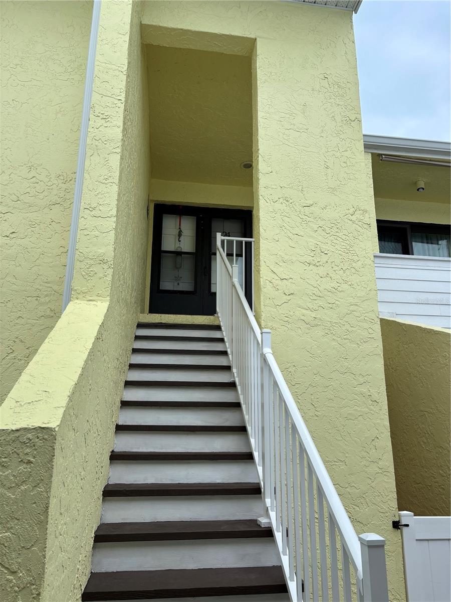 * Back on the market after recent renovation!!!  Check out this very nice second floor condo in this intracoastal community in Indian Rocks Beach area. This beautiful unit has just been enhanced with a brand new renovation that includes new light gray paint throughout along with a very nice new laminate floor in the living room area.  All of the ceilings have also been renovated and painted. This unit is close to the clubhouse which has a beautiful pool area right on the intracoastal waterway for great relaxation!  The front balcony area opens into a nice dining area followed by a fireplace in the living room.  In the kitchen area closet you will find a conveniently placed stacked washer and dryer along with renovated white cabinets and nice appliances.  The refrigerator was new in 2022 and the AC condenser and air handler were both replaced in 2025. The 2 bedrooms have nice laminate flooring and ceiling fans.  This condo features all new windows and had NO flood or wind damage during the hurricane season of 2024.  You will love the close walk to the beach from this complex and enjoy great views of the intracoastal waterway from the pool area. Come take a look at this beautiful place!