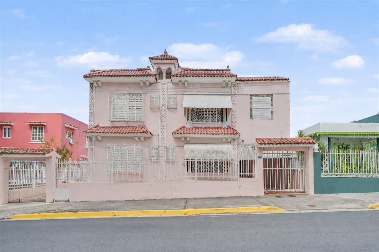 Price Improvement! Discover a property full of character and architectural charm, located in the heart of Sagrado Corazón Historic District — not in Old San Juan, yet offering a similar historic ambiance with its own unique identity.
Built in the 1940s on an approximately 510-square-meter lot, with an estimated 3,341 sq ft of Gross Living Area, this residence showcases distinctive period features, including high ceilings, original architectural details, and a spacious, flexible layout that creates a warm and inviting atmosphere for both living and investment purposes.
The property offers a total of 7 bedrooms and 4 bathrooms, distributed as 4BD/2BA on the ground level and 3BD/2BA on the upper level, providing multiple possibilities for residential, multi-generational, or potential combined-use configurations, subject to applicable permits.
Preserved historic elements enhance long-term value and an excellent foundation for restoration, adaptive reuse, or income-producing opportunities in accordance with Historic District guidelines.
Additional features include a galley-style kitchen, vintage bathrooms, two service rooms, rear patios, an approximately 450-gallon cistern, a backup power generator, a garage, and a driveway accommodating approximately four vehicles.
Conveniently located in a walkable urban setting, the property is in close proximity to universities, retail, dining, public transportation, and major access routes throughout San Juan, offering excellent accessibility while maintaining its historic character.
Whether you are looking for a primary residence, a second home, or an investment opportunity, this property presents strong potential due to its location, versatility, and architectural appeal.
A rare opportunity to acquire a historic-style property in Sagrado Corazón, ideal for buyers who value character, flexibility, and long-term investment potential.
Property is located in the Sagrado Corazón Historic District and not in Old San Juan.
Mortgage pre-qualification letter or proof of funds required to schedule showings.