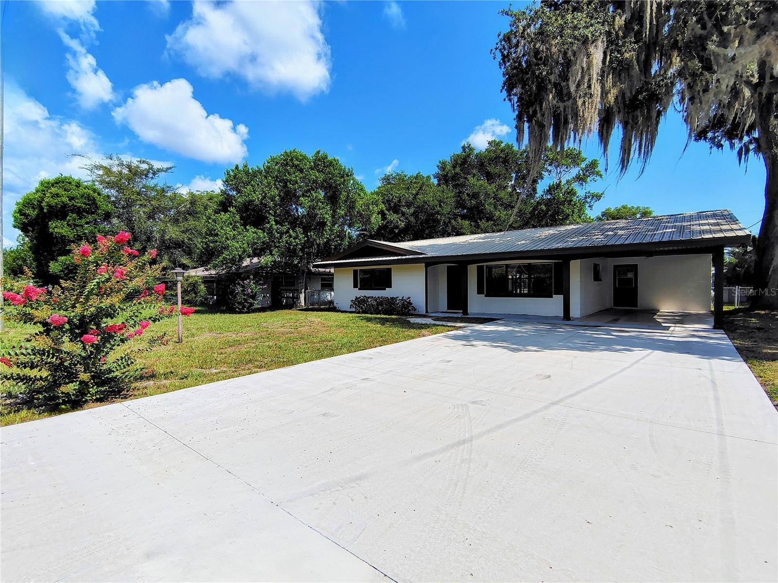 Move-in ready and full of recent upgrades, this charming Lake Panasoffkee home is ready for its new owners! From the moment you arrive, you'll notice the new concrete driveway (2026), adding both curb appeal and convenient parking. Step inside to discover a bright, refreshed interior featuring a fresh coat of paint throughout the entire home, creating a clean, modern feel. Stay comfortable year-round with a new A/C system (2026), providing peace of mind for years to come. The home's functional floor plan offers comfortable living spaces with plenty of natural light, making it perfect for both everyday living and entertaining. Recent improvements continue with new flooring in the mudroom and both bathrooms, adding a fresh touch to these high-traffic areas. Enjoy the benefits of an optional HOA, where membership provides access to a private community boat ramp with direct access to beautiful Lake Panasoffkee that flows right into the scenic Withlacoochee River, where you can enjoy boating, kayaking, and the view of an abundance of native wildlife. Enjoy the small-town charm while still being just minutes from The Villages that hosts free nightly entertainment, golf courses, shopping, dining, and much more! You're also close to Florida’s west coast, offering waterfront dining, kayaking, fishing, beaches, and natural springs for the perfect weekend adventures. Convenient access to I-75 and the Florida Turnpike makes travel to Orlando’s theme parks and major airports a breeze. This home gives the perfect blend of comfort, privacy, and convenience to the Florida lifestyle. Equal Housing Opportunity.