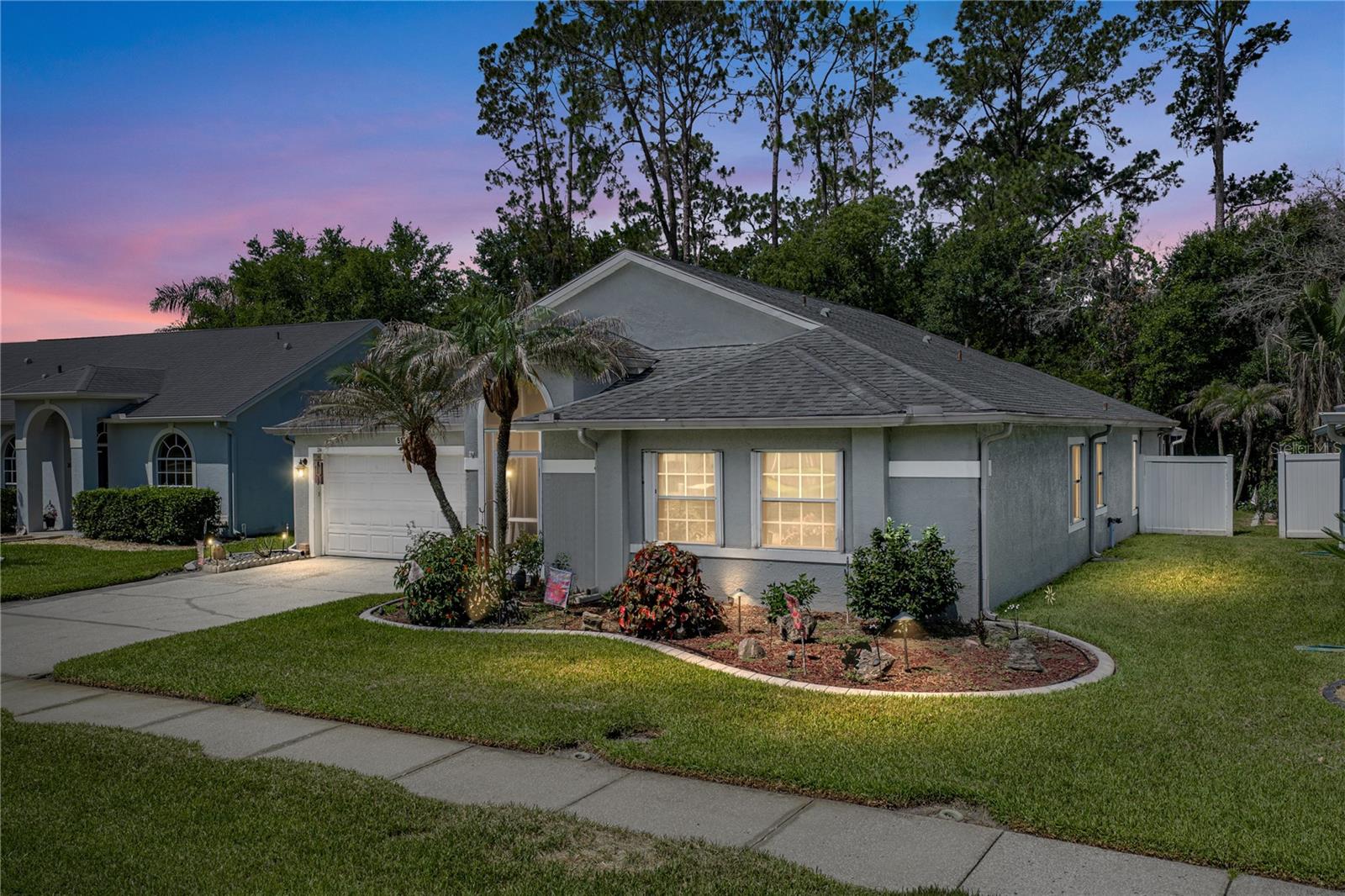 A must see with a new AC! This 4 bedroom, 2 bath, 2 car garage home rests within the amenity-rich community of Lake Bernadette. Featuring a 1400+ sq ft screened patio, high ceilings, an updated kitchen and bathrooms, and an expansive family room, this home is ideal for entertaining and comfortable living. A lush mature landscape, sidewalk-lined streets, and a screened, covered entryway provide a warm welcome to the property. Step inside to soaring 12’ ceilings, luxury vinyl plank flooring throughout the main living areas, and crown molding in the entire home. A stone-accented feature wall adds an extra touch of character to the space. The 14x24 family room offers high vaulted ceilings, sliding doors to the screened porch, and easy access to the spacious and updated kitchen with two-toned cabinetry, epoxy-coated tile countertops, breakfast bar seating, a large eat-in dining room, and a 4-piece appliance package. The primary bedroom has been split away from the other bedrooms for privacy. It has 2 walk-in closets and an ensuite bathroom with 2 sinks, a vanity seat, a custom walk-in shower with decorative tile and a glass enclosure, and a water closet. Bedrooms 2-4 are on the opposite side of the home. Each provides a ceiling fan, carpet flooring, built-in closets, and proximity to the fully updated secondary bathroom. A huge screened lanai creates an amazing opportunity to utilize the wooded view backyard year-round and mosquito-free! The outdoor kitchen makes it easy to cook outdoors and provides a seamless indoor/outdoor living experience. All this and more resides within the coveted Lake Bernadette community of Zephyrhills. Residents here enjoy access to a sparkling swimming pool, a playground, tennis courts, and an updated clubhouse with an event room/kitchen and a fitness center. Call us today for more information and your private viewing! Roof 2013 | AC 2026 | Water Heater 2019 | Interior Paint 2020 | Exterior Paint 2019 | Epoxy Garage Floor 2022 | Microwave 2022 | Washer Dryer 2023 | Exterior of the home power washed June 2026 |