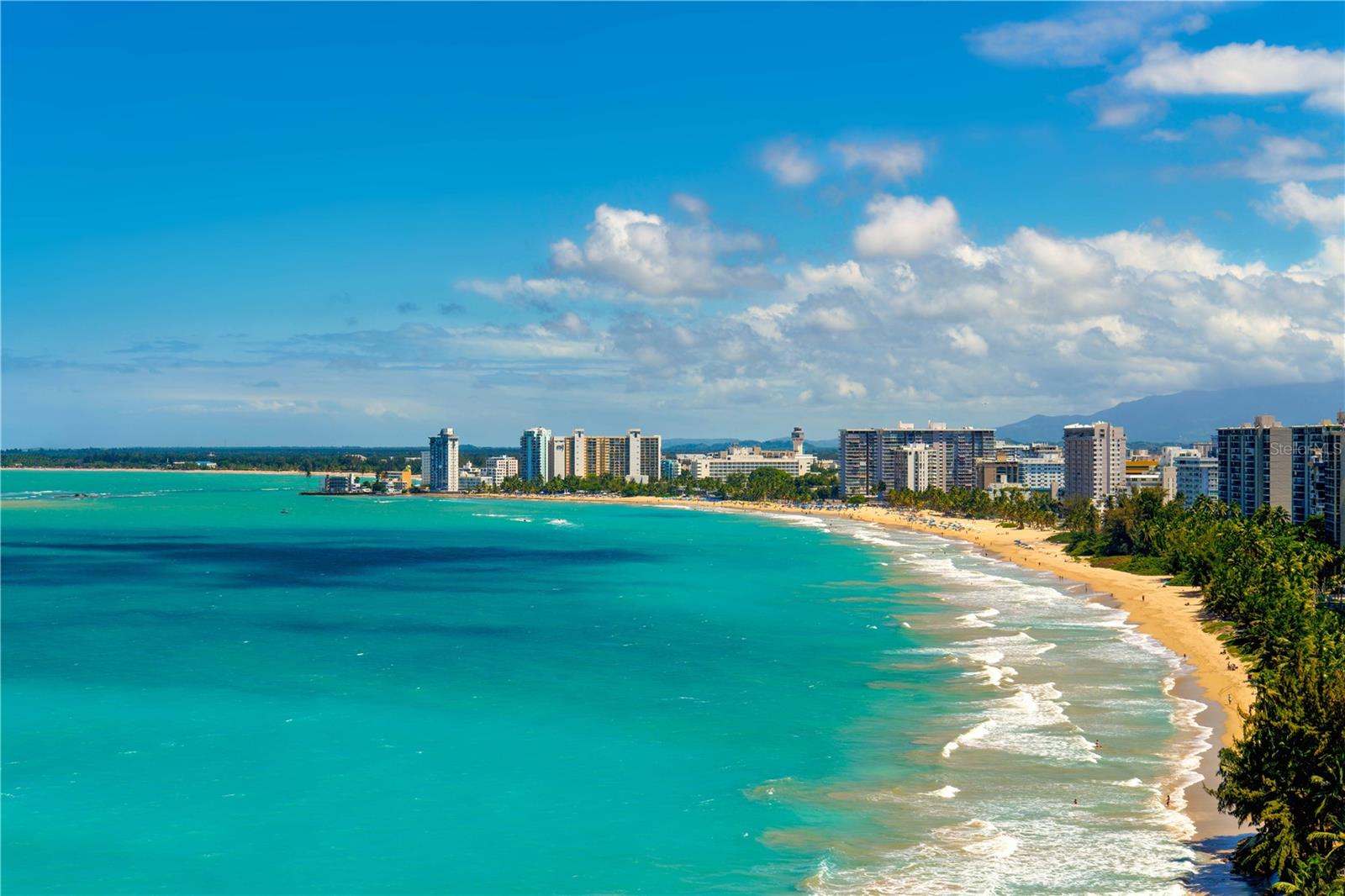 One or more photo(s) has been virtually staged. ***SOLD*** Nestled in the heart of the serene beaches of Isla Verde, this one-of-a-kind penthouse is truly a rare treasure. This expansive two-story penthouse, newly remodeled for the utmost sophistication and comfort, offers over 6,100 +- square feet of interior living space and approximately 1,400 square feet of wrap-around terrace, providing breathtaking panoramic views encompassing the ocean, lagoon and mountains. Upon entering the entertaining floor, you will be greeted by a sleek and open kitchen seamlessly flowing into the dining room. The formal living room boasts ocean views and a wet bar, perfect for entertaining guests, while a family living room on the south side offers serene vistas of Laguna los Corozos. The spacious wood-paneled wine cellar adds to the allure, an ideal room for any wine connoisseur. Floor-to-ceiling sliding glass doors throughout the apartment provide an indoor/outdoor feel with uninterrupted views. Ascend to the second floor where you will step into a hallway adorned with floor-to-ceiling glass, offering mesmerizing views of the beach and ocean. The west wing has four guest bedrooms, each offering comfort and privacy. The primary suite sits alone facing north featuring its own balcony, inviting in the soothing sights and sounds of the ocean. The primary bathroom is a sanctuary unto itself, with a separate tub where you can luxuriate while gazing at the lagoon. Two individual walk-in closets provide luxurious storage space and convenience. Surfside Mansions offers resort-style amenities, including direct beach access and a pool, allowing residents to enjoy the sun and pristine shores of Isla Verde. Additionally, the unit comes with four dedicated parking spots, ensuring convenience and ease of access for residents and guests alike. Photos 2, 4, 6, 9, 12, 17, 18, 25 and 28 are virtually staged and do not reflect the current state of the property.