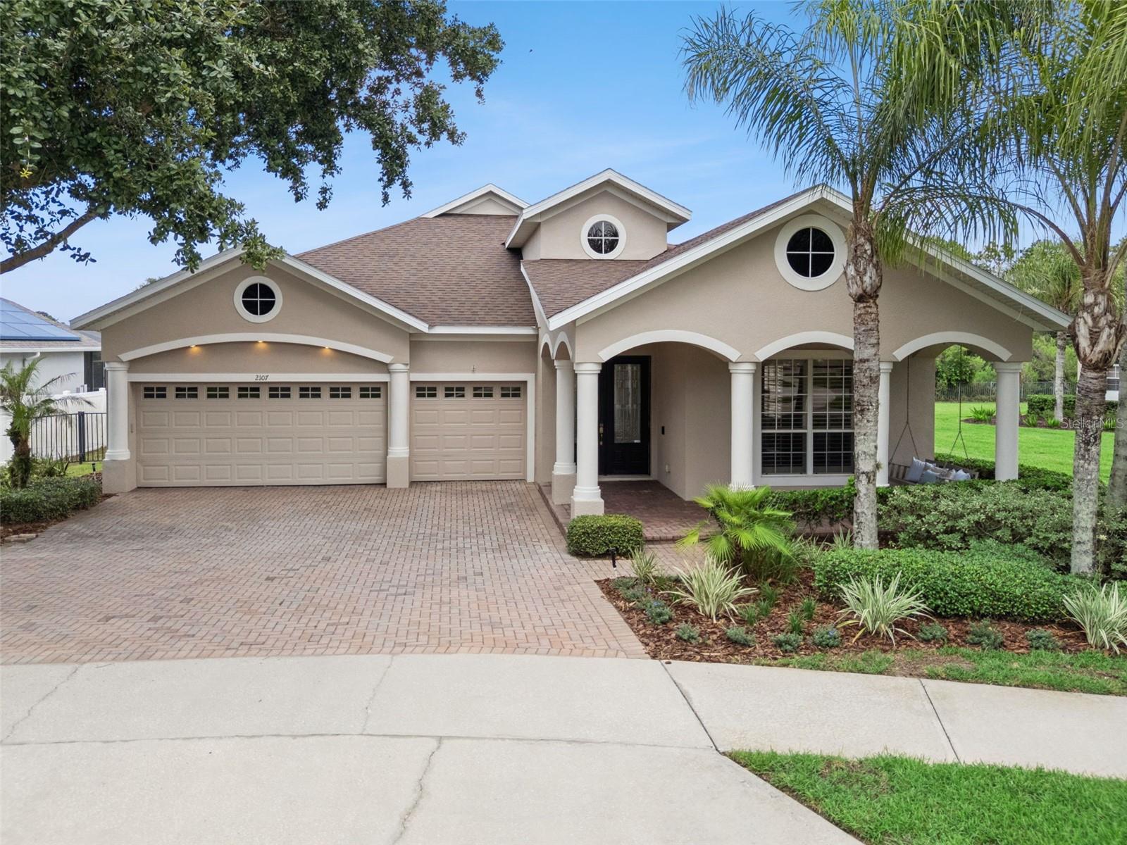 Welcome to this beautifully maintained residence in the highly sought-after gated community of Carriage Pointe in Winter Garden. Built in 2009, this spacious residence offers 2,826 square feet, 4 bedrooms, 3 full bathrooms, and a full 3-car garage, all thoughtfully designed around an ideal three-way split floor plan that provides privacy and flexibility for families and guests alike. From the moment you arrive, you'll be welcomed by a charming covered front porch complete with a porch swing—the perfect place to relax and enjoy the neighborhood. Inside, soaring ceilings, plantation shutters, engineered hardwood flooring throughout the main living areas, updated lighting and ceiling fans, and elegant crown and chair rail molding in the formal dining room create a warm and inviting first impression. Formal living and dining rooms greet you at the front of the home before opening into the heart of the house. The spacious kitchen is designed for both everyday living and entertaining, featuring granite countertops, an oversized island with bar seating, stainless steel appliances, 42-inch upper cabinets with crown molding, a decorative herringbone tile backsplash, and abundant cabinet and counter space. The kitchen flows seamlessly into the expansive great room, where large sliding glass doors showcase one of the home's most spectacular features—the private backyard oasis. Step outside to your own resort-style retreat featuring a gas-heated saltwater plunge pool, an expansive covered lanai, and a fully fenced backyard. The elevated homesite overlooks peaceful conservation with no rear neighbors, creating exceptional privacy and a boutique resort feel that's rarely found. Whether you're enjoying a quiet morning coffee or entertaining friends and family, this outdoor living space is truly the centerpiece of the home. The spacious primary suite is privately situated at the rear of the home and enjoys tranquil backyard views, a tray ceiling, abundant natural light, a custom-designed walk-in closet, and private access to the covered lanai. The luxurious primary bathroom features separate vanities, a garden tub, and an oversized walk-in shower. The thoughtfully designed three-way split floor plan offers exceptional privacy, with one guest bedroom and full bath tucked away near the center of the home, while two additional bedrooms share a full pool bath with direct access to the outdoor living area. Additional upgrades include a brand-new roof (2026), AC (2023), and water heater (2022)—meaning all of the home's major mechanical systems have already been updated, providing tremendous peace of mind for the next owner. The oversized 3-car garage is equally impressive with premium Husky storage cabinets, wall-mounted organization systems, two ceiling-mounted storage racks, and wiring already in place for a future electric vehicle charger. Additional improvements include whole-house surge protection and a spacious interior laundry room complete with a utility sink and upper cabinetry. Residents of Carriage Pointe enjoy the security of two gated entrances along with community amenities including a playground, tennis court, and soccer field. Conveniently located near Winter Garden's shopping, dining, major roadways, and top-rated schools, this exceptional home offers the perfect combination of thoughtful upgrades, resort-style outdoor living, and peaceful conservation views. Make an appointment so see this home today!